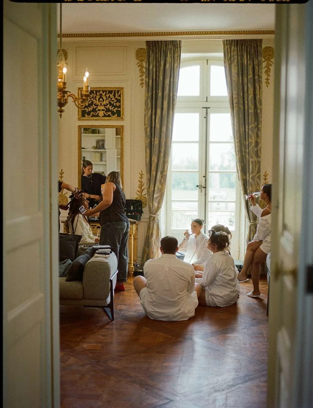 People preparing for a wedding or event in a luxurious room.