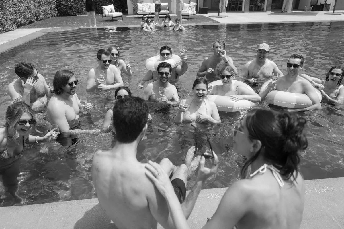 A group of people enjoying a pool party, smiling and laughing together.