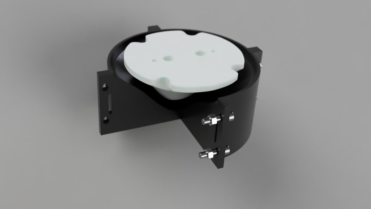 Image d'un moule mécanique circulaire noire avec une contre forme blanche en haut, fixée avec des boulons.