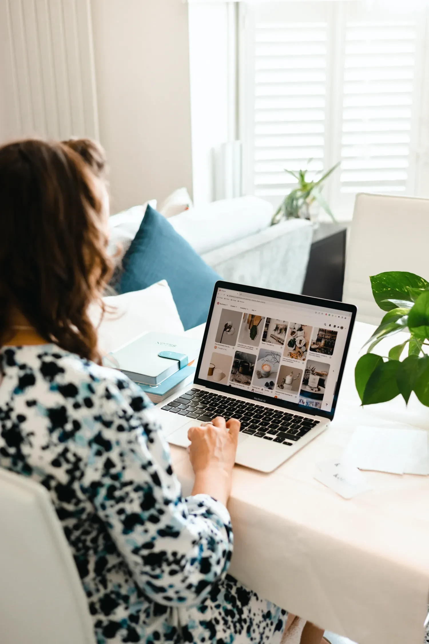 Sammy Phillips sitting at her laptop working on Squarespace template customisation service