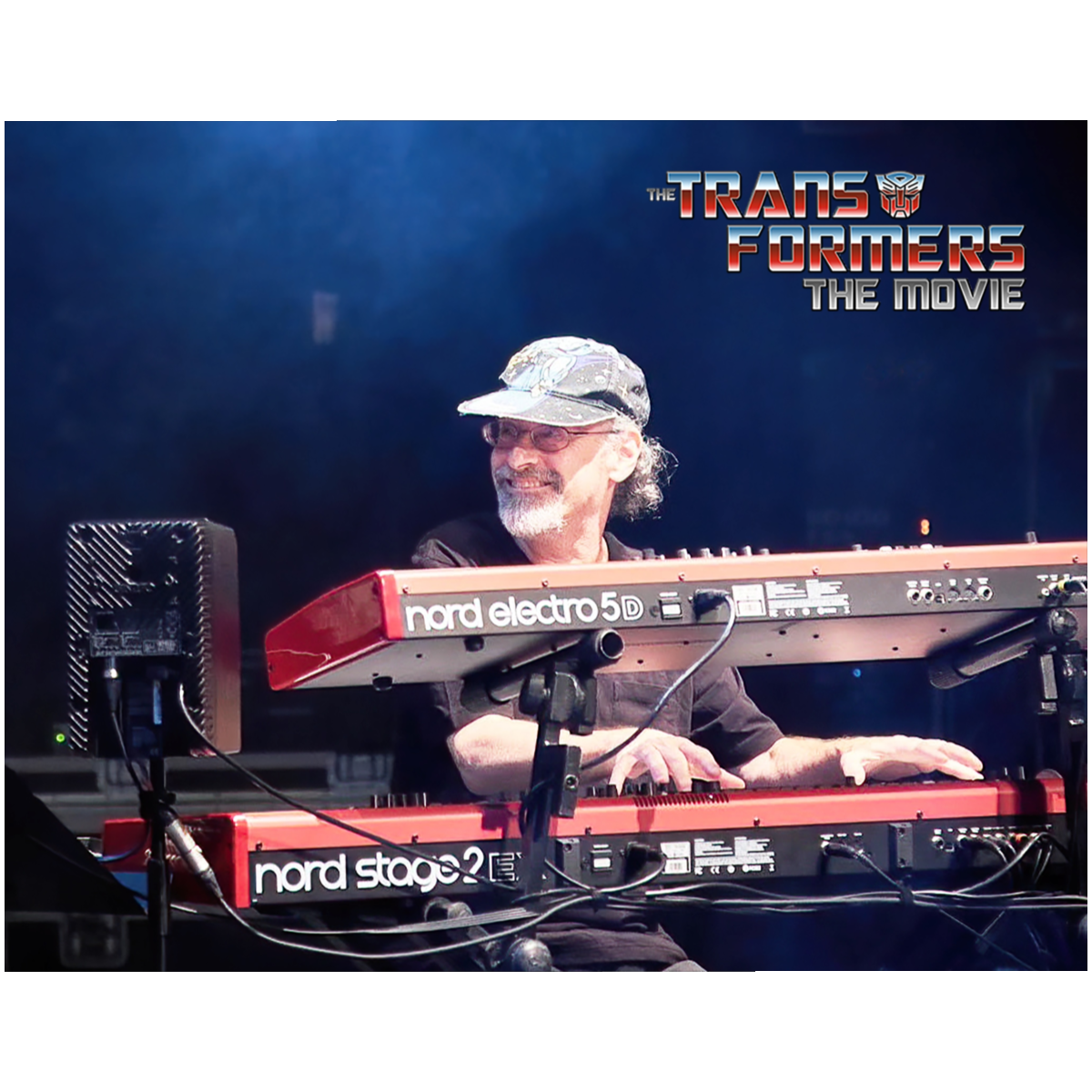 Front view of the Official Vince DiCola 8x10 glossy photo print — Vince DiCola live at his red Nord keyboards under blue stage light