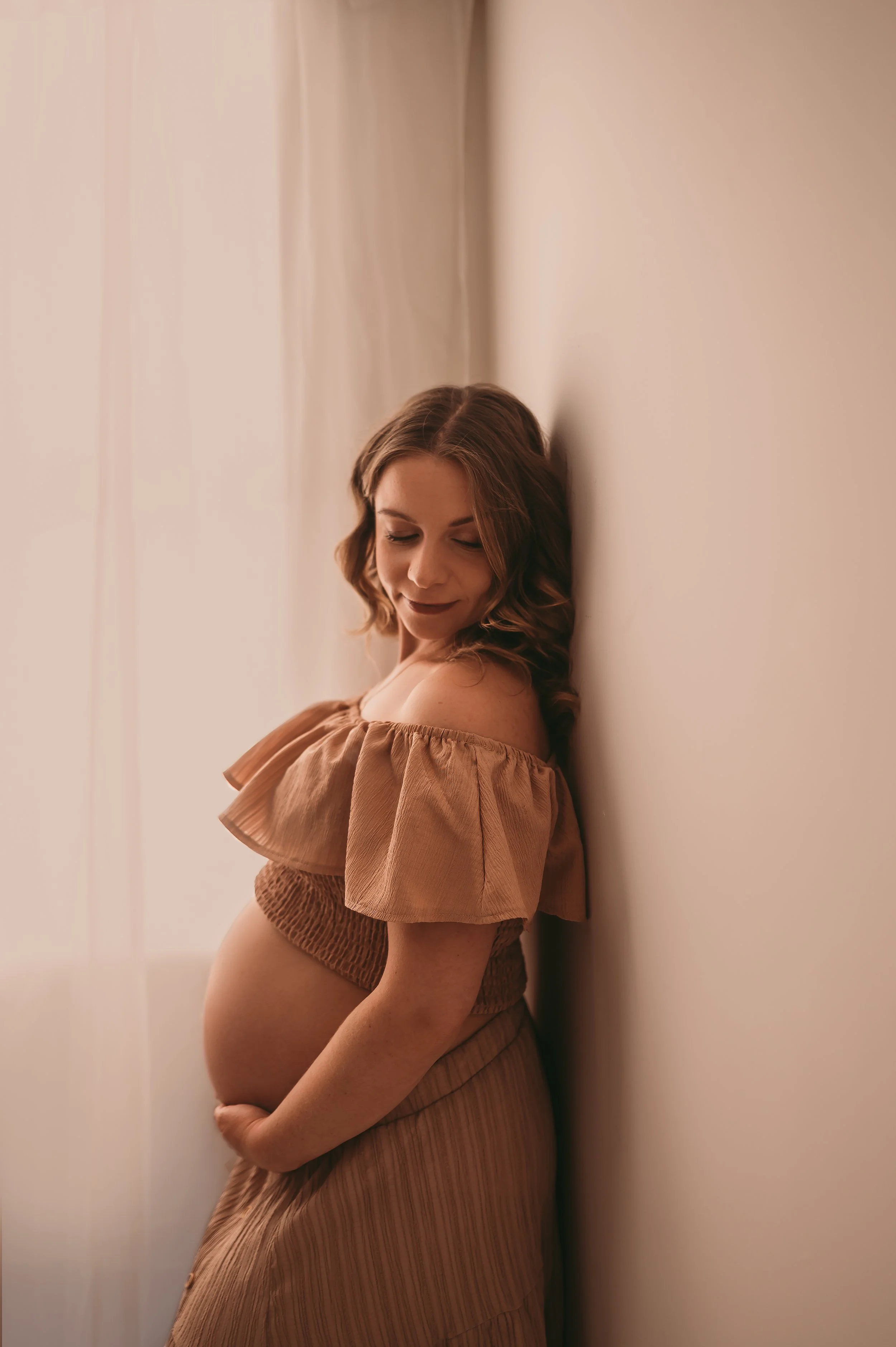 Pregnant Mother photographed in a studio near Somerset, wearing a two piece, crop top and skirt showing off baby bump