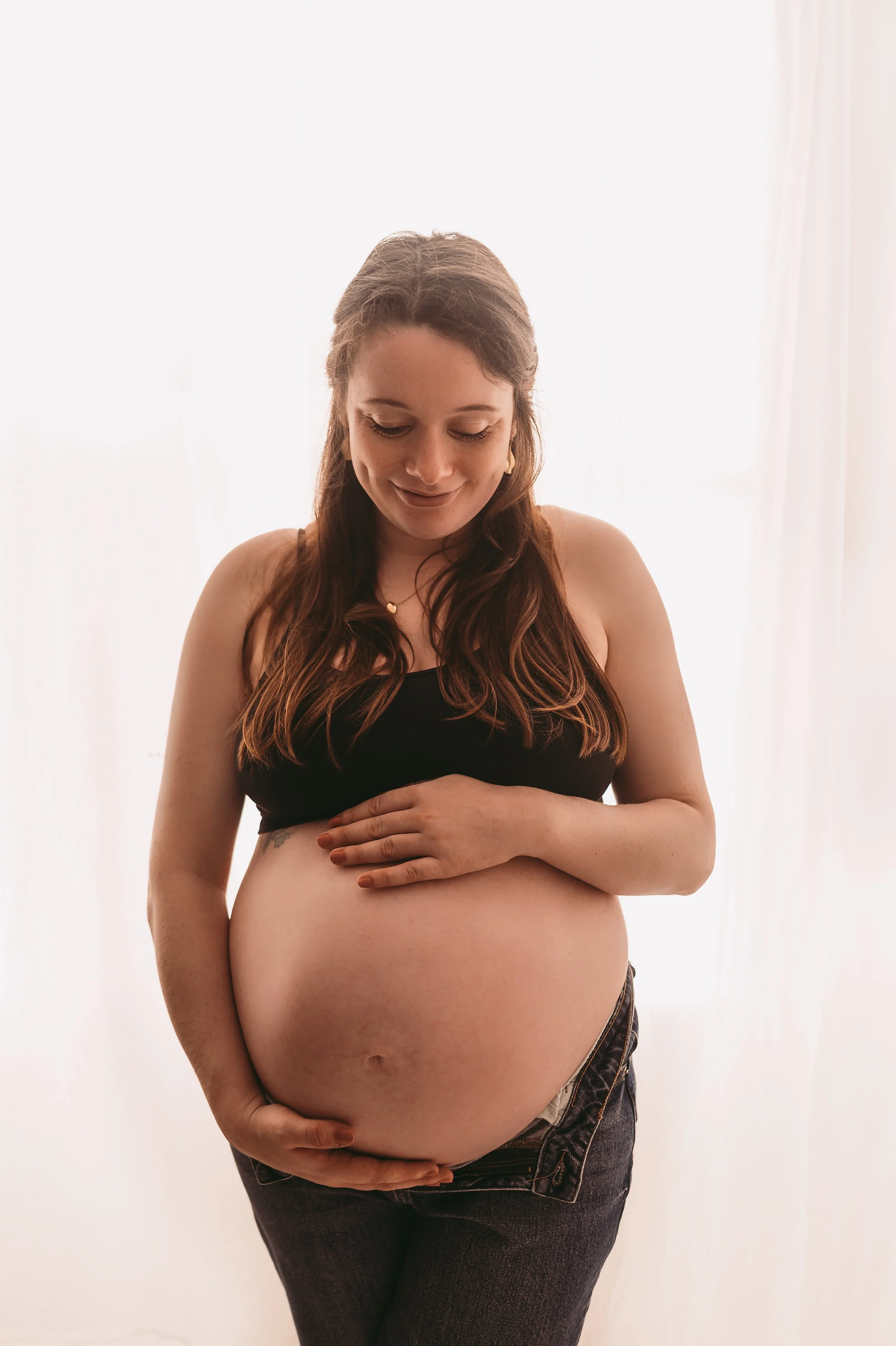 A mother to be at 38 weeks pregnant, holding baby bump,  Maternity photography by kp-photo, based in Wiltshire