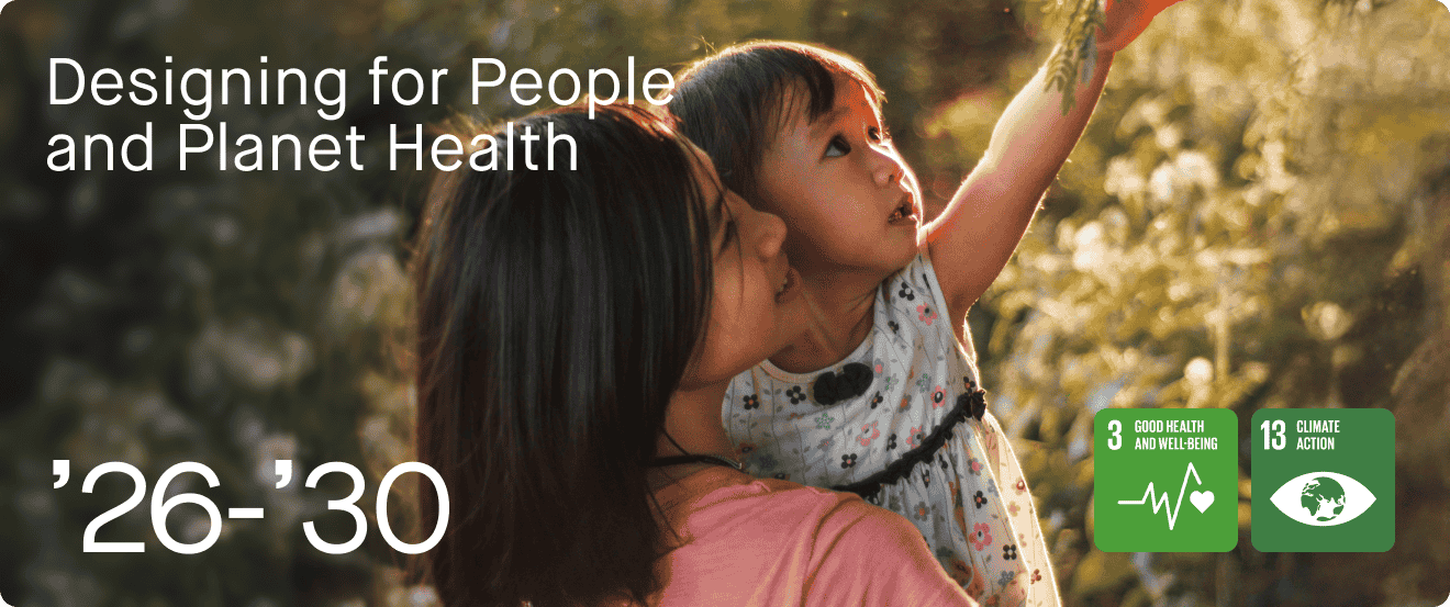 A woman holding a young girl outdoors during sunset. The woman is kissing the girl on the cheek, and the girl is reaching up, touching a tree branch. Background features blurred trees and golden sunlight. Overlaid text reads 'Designing for People and Planet Health,' with icons indicating goals for good health and climate action.