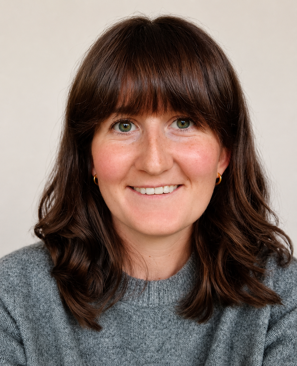 Headshot of smiling woman with dark hair.