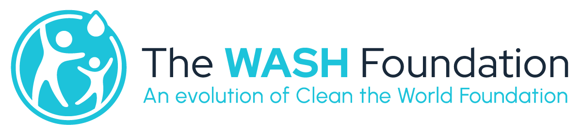 The logo of The WASH Foundation featuring a circular emblem with abstract figures and water drops, along with the text "The WASH Foundation" and the motto "An evolution of Clean the World Foundation."