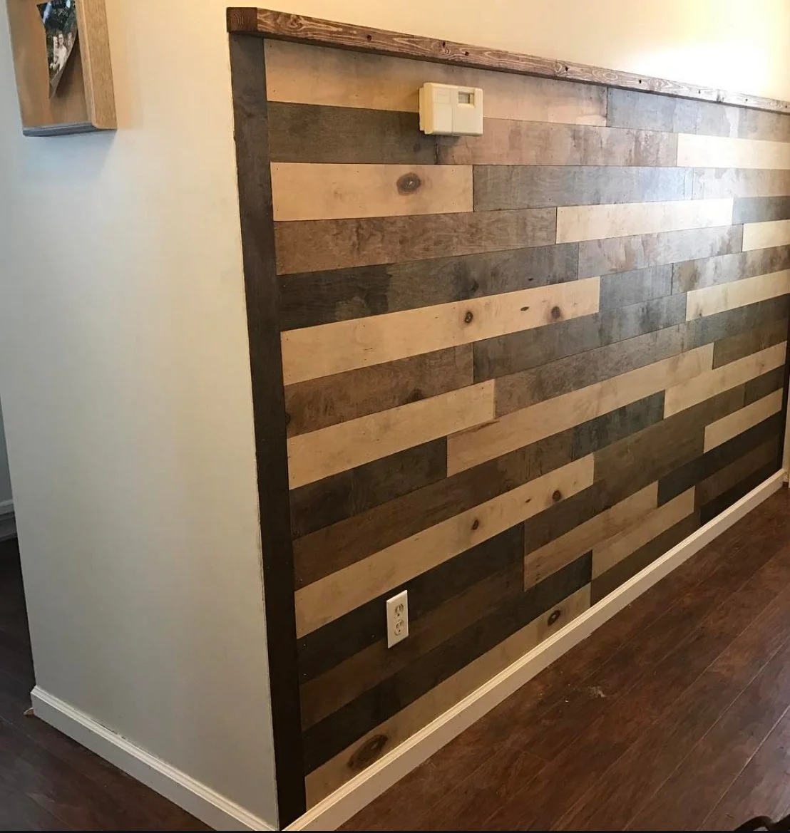 Wall with horizontal wooden planks and a wooden trim on top.