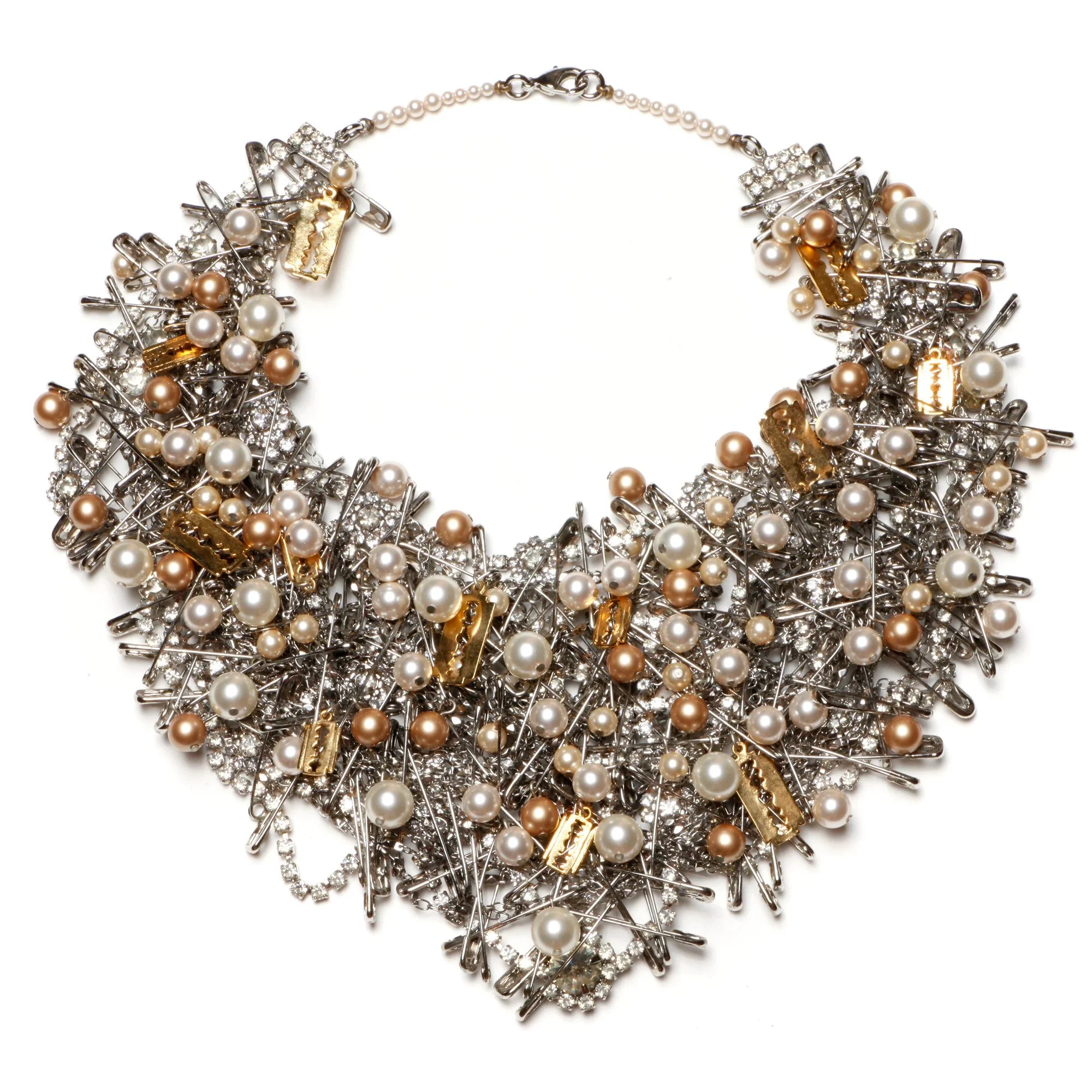 A necklace made of silver safety pins decorated with pearls and small gold charms.
