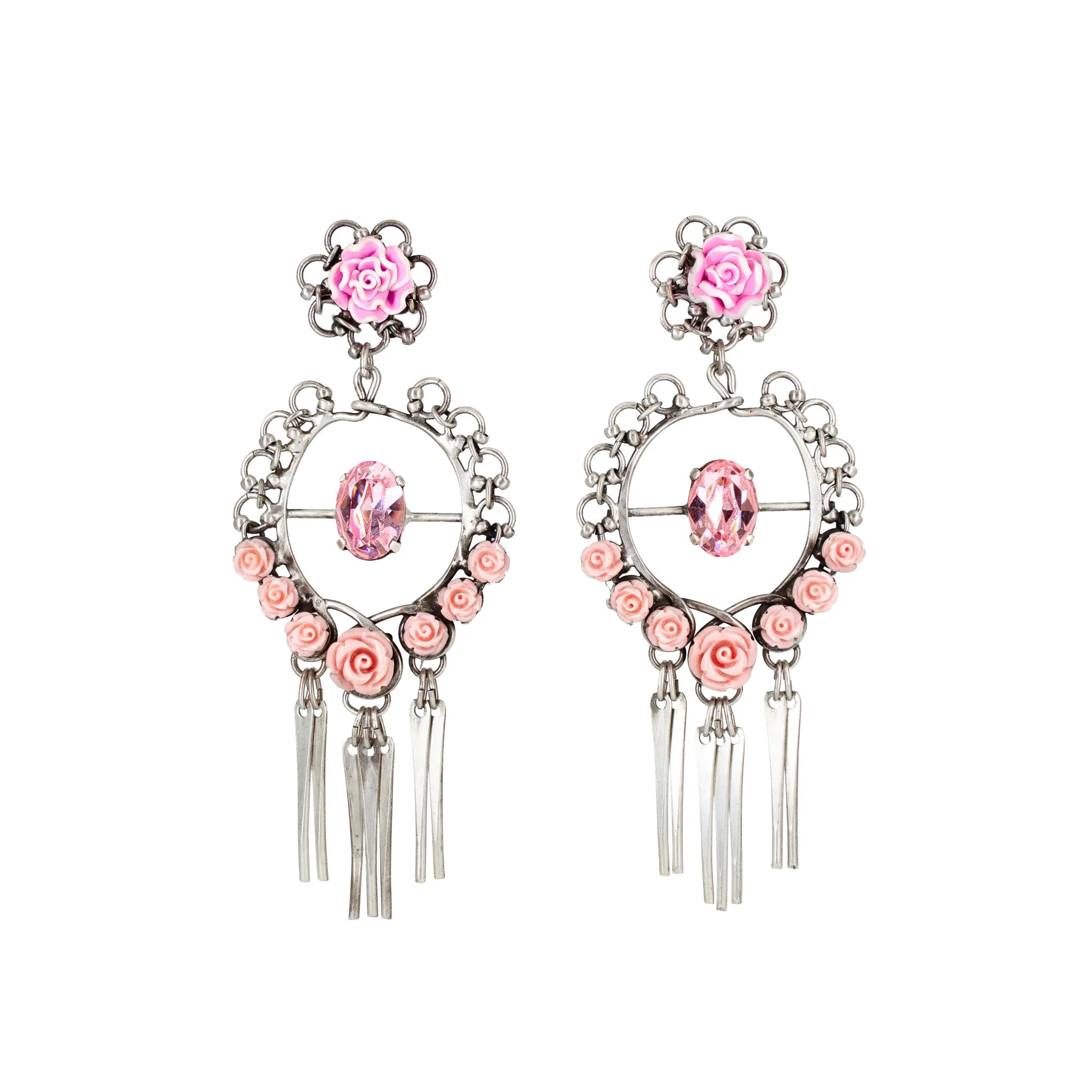 Pink and silver dangling earrings with pink roses, pink gemstone center, and hanging silver tassels.