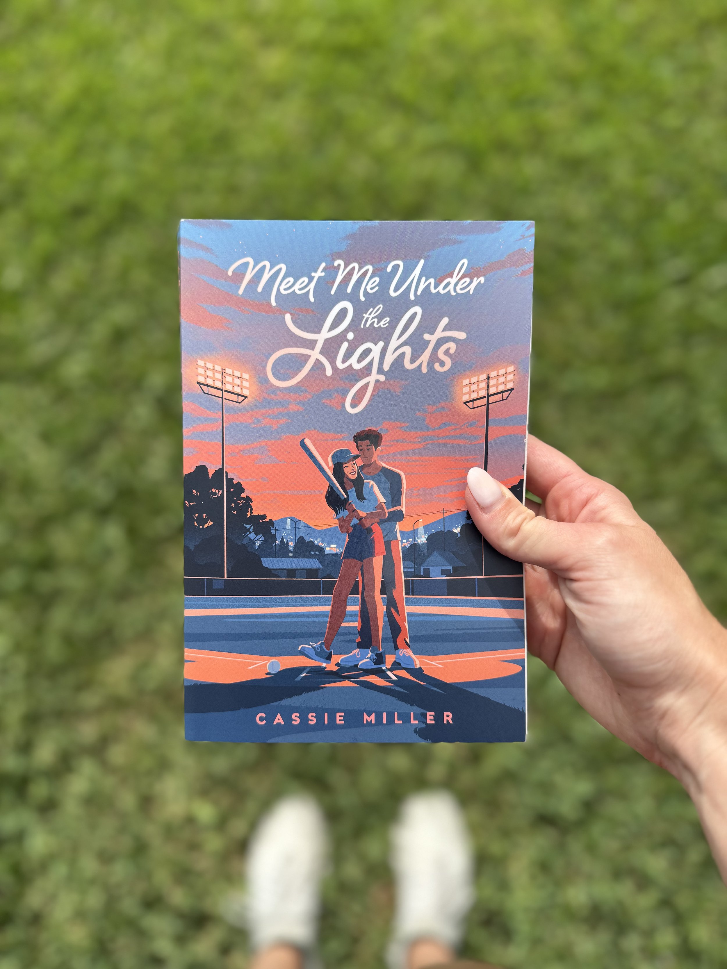 “Meet Me Under The Lights” by Cassie Miller
