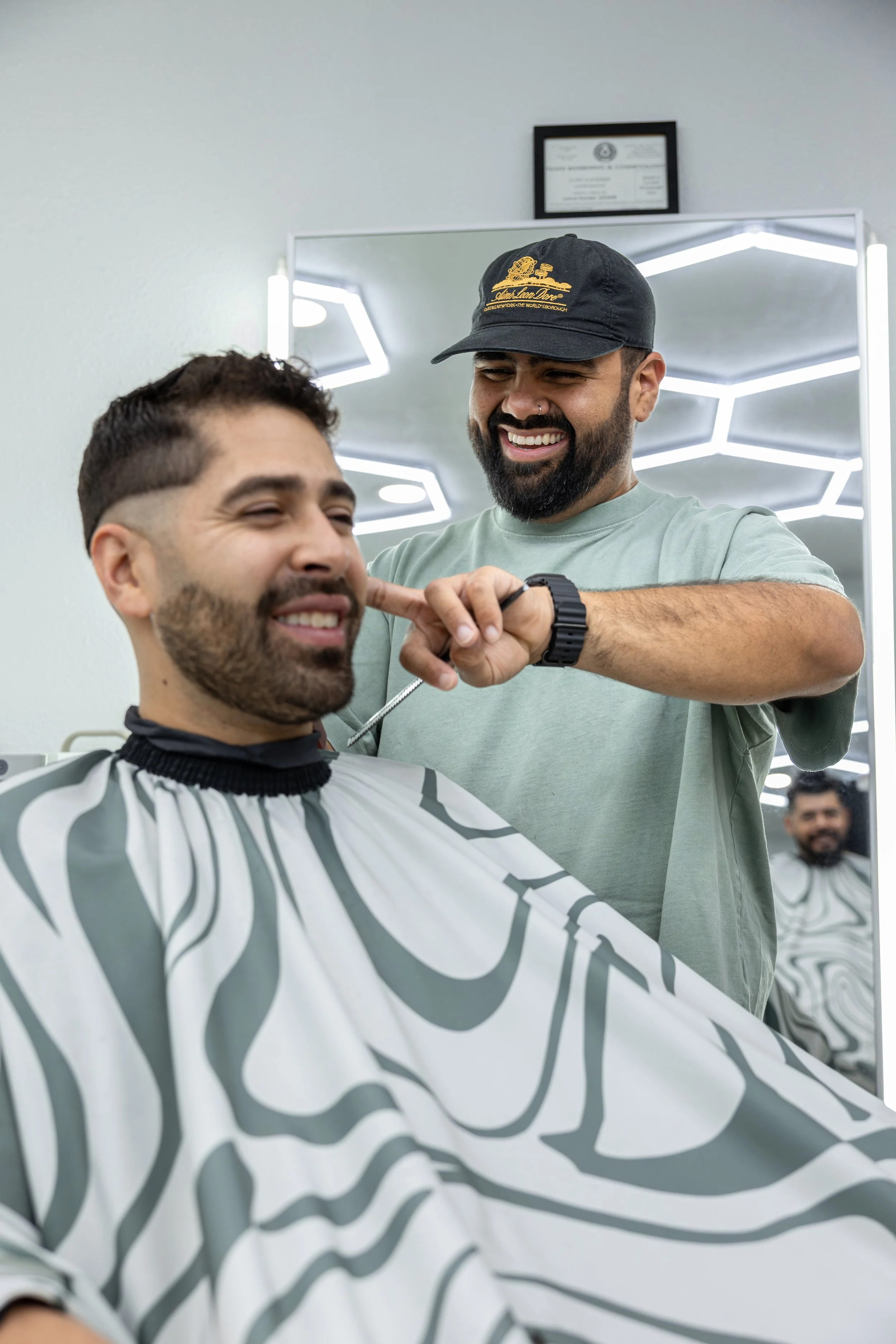 Barber cutting a man's hair at common space barbershop in South Austin