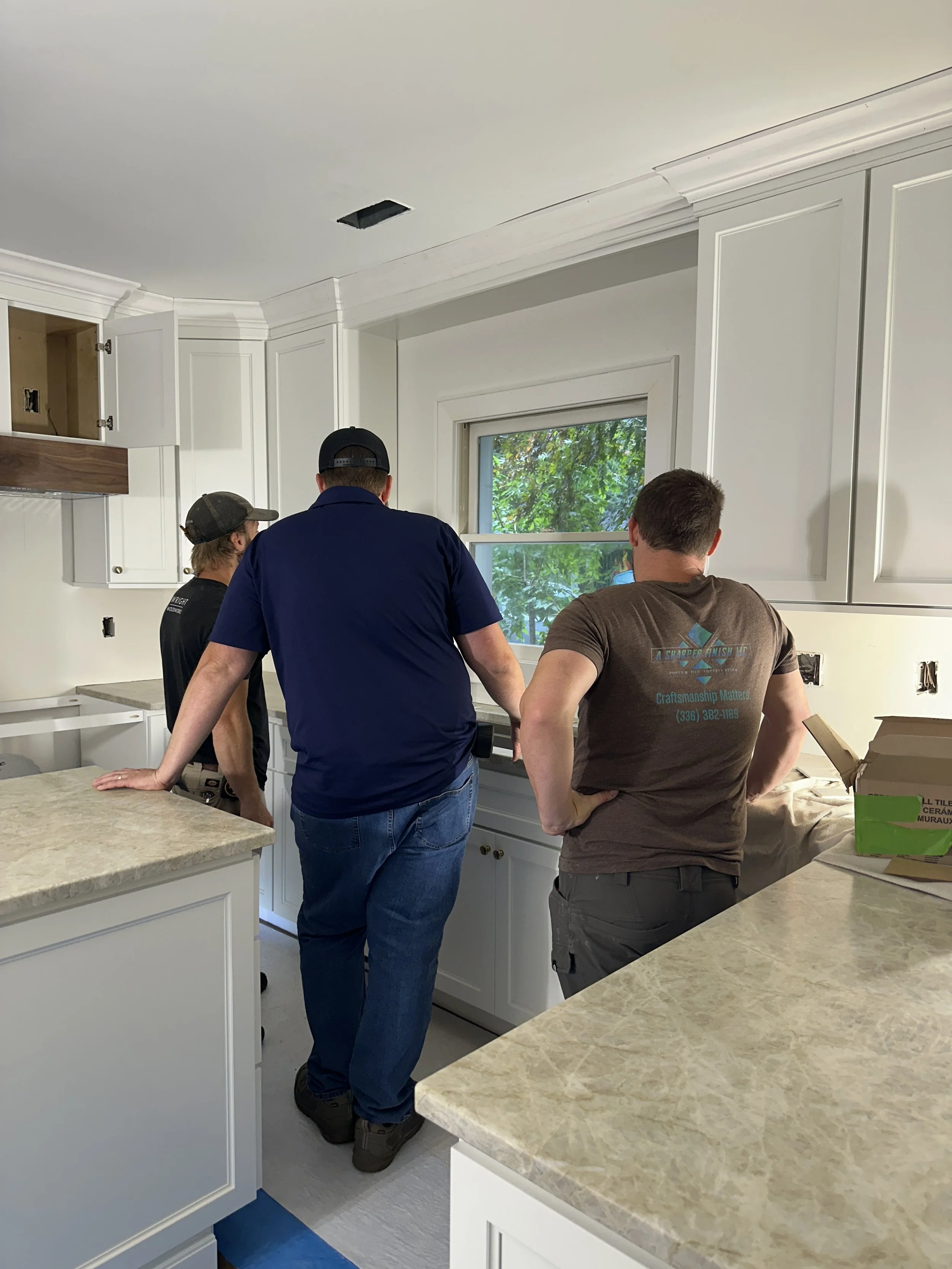 Riverside Construction crew working in kitchen during remodel, Winston-Salem NC