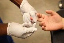 JOE RAEDLE | GETTY IMAGES
A medical assistant draws blood from a patient on National HIV Testing Day at a Planned Parenthood health center in Miami in 2017. Blacks and Hispanics experience a disproportionate burden of HIV infection, according to CDC
