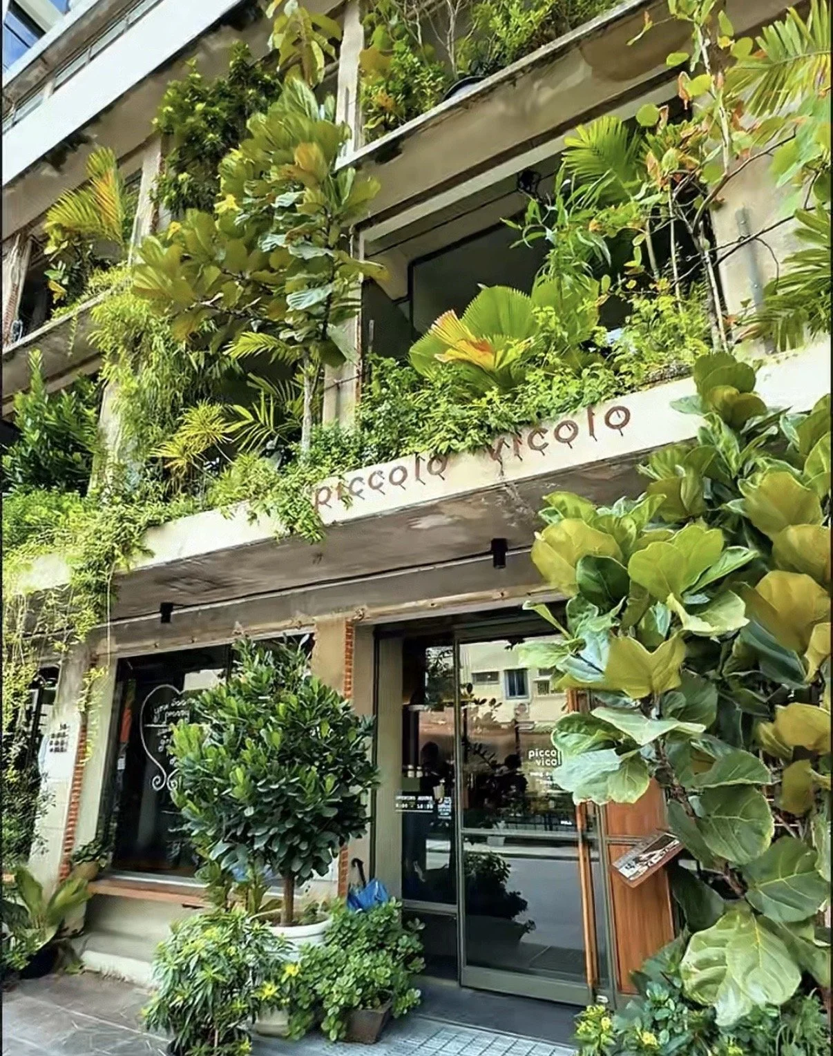 The rustic canal-side exterior entrance of Piccolo Vicolo cafe in Bangkok