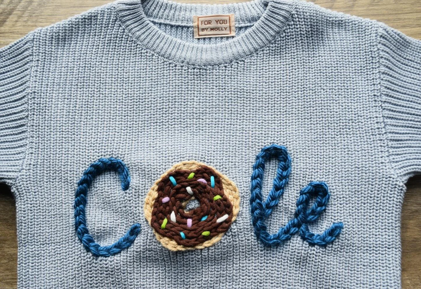 You&rsquo;ve heard of a donut hole, but have you heard of a donut Cole? 😂 Now you have!! 🍩🩵

Obsessed with how this sweater turned out!! We did a light blue sweater with the dark blue lettering, and the cutest donut for the letter &lsquo;o&rsquo;!
