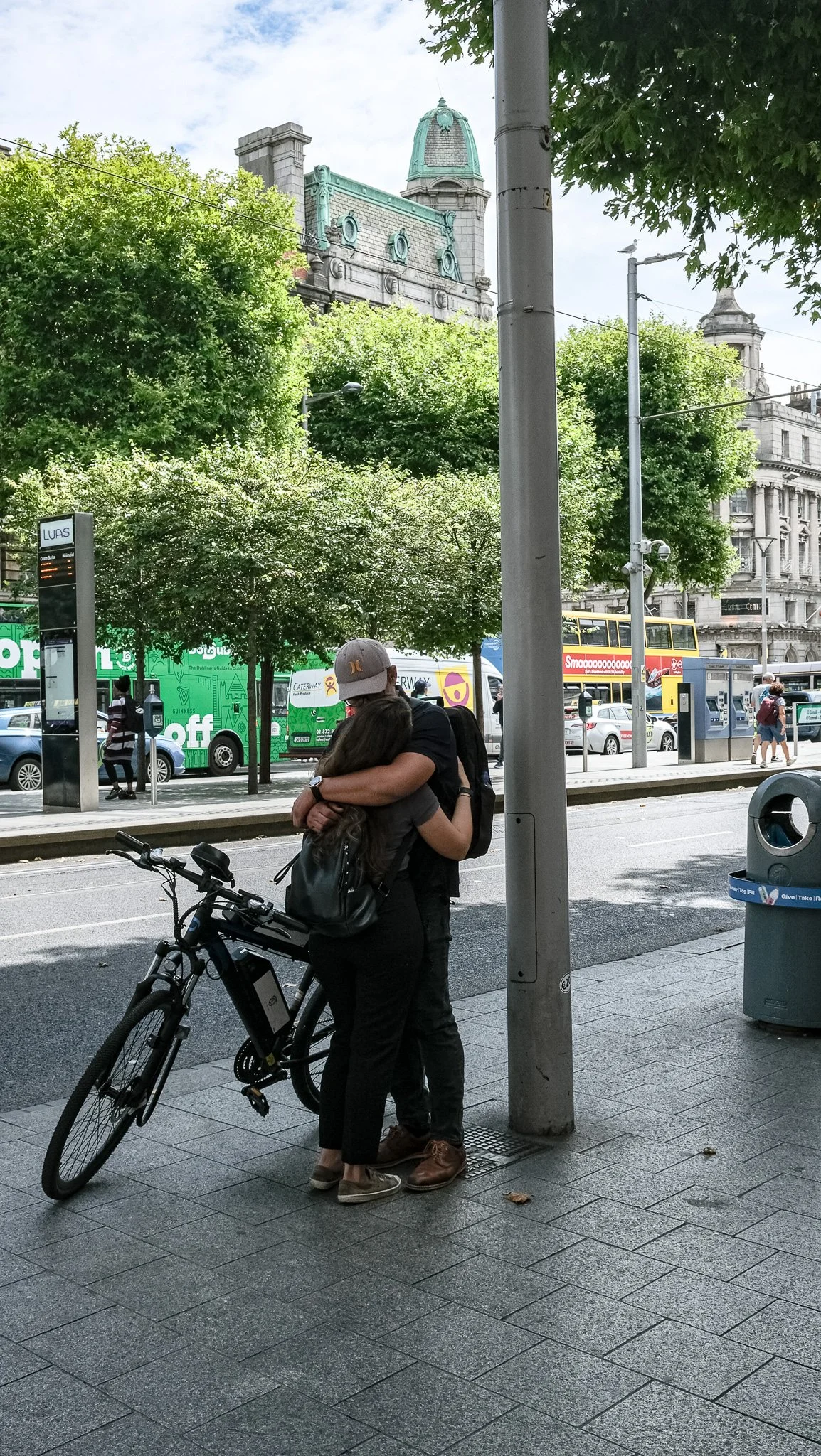 Romance on O'Connell Street, Dublin, Ireland. Two people embrace.
