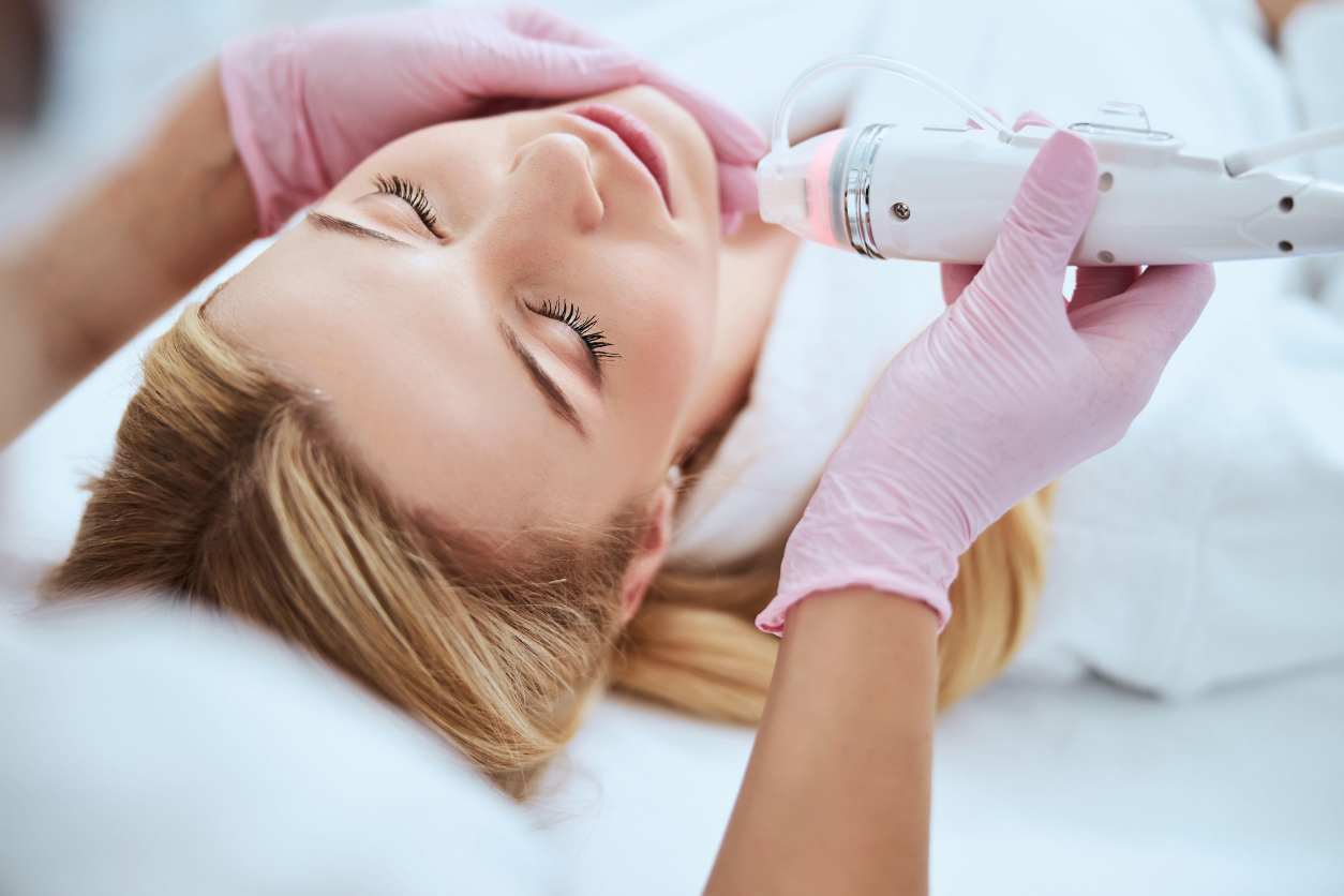Woman receiving Morpheus8 skin tightening treatment on the face at a medspa