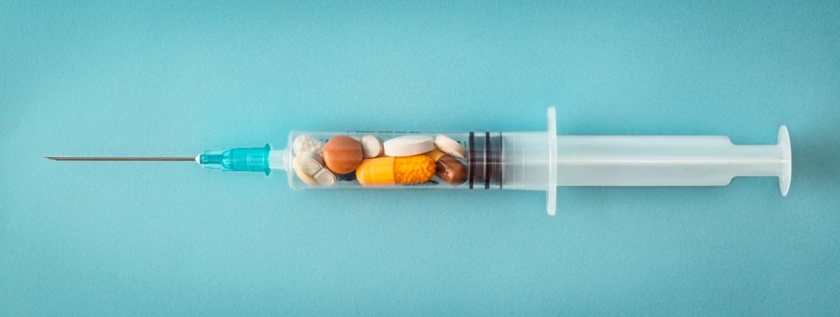 Syringe filled with an assortment of vitamins