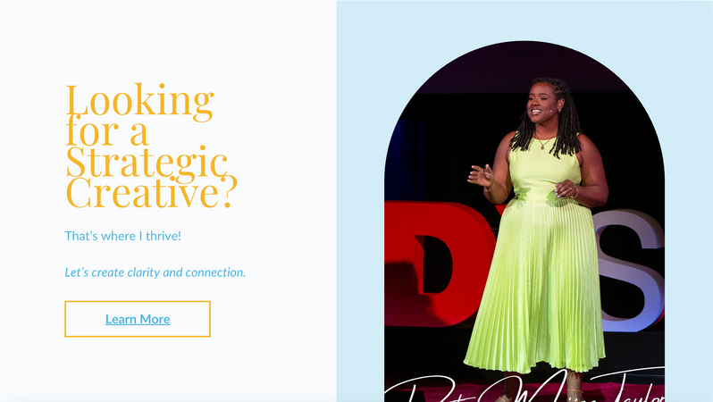 A woman standing on a stage, smiling and speaking, dressed in a bright yellow pleated dress, with TEDx and other large letters in the background.