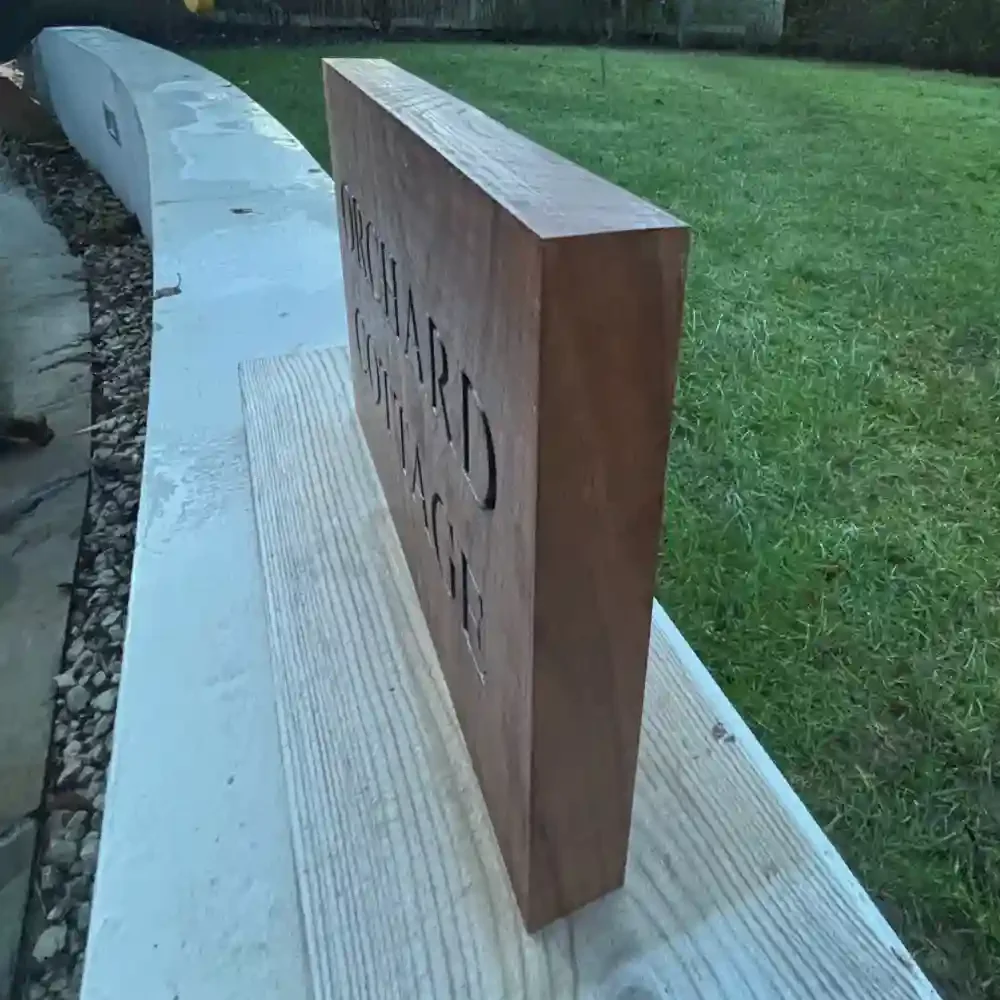 Walnut rectangle-engraved-sign with black text and no border side view