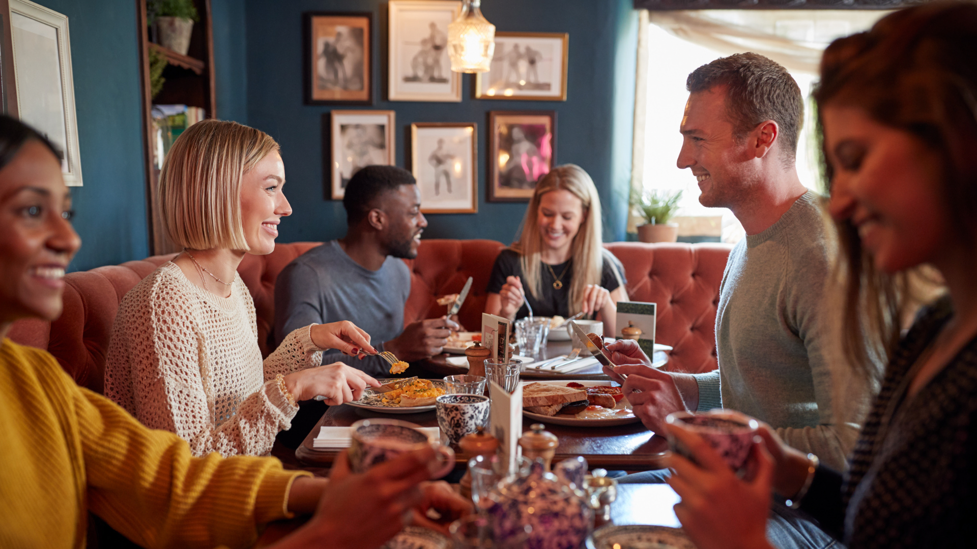 Restaurant patrons enjoying a safe dining experience supported by commercial kitchen compliance, range hood cleaning and electrical test and tag services.