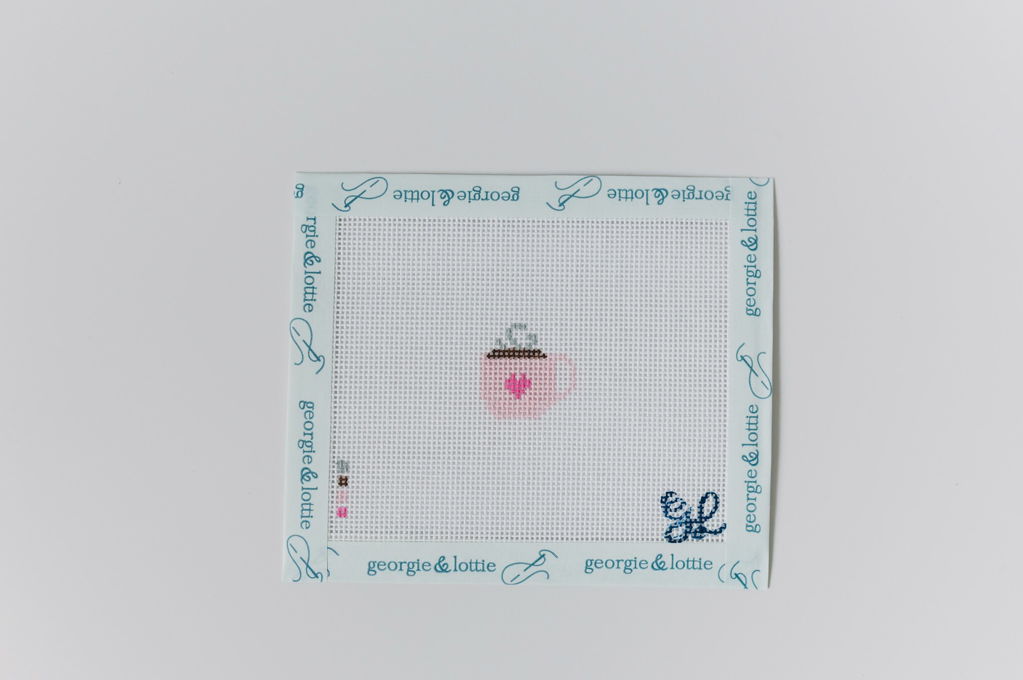 Hand-painted Georgie & Lottie “Sweetheart Sip” mini needlepoint bag tag kit with blush mug design on 18 mesh canvas.