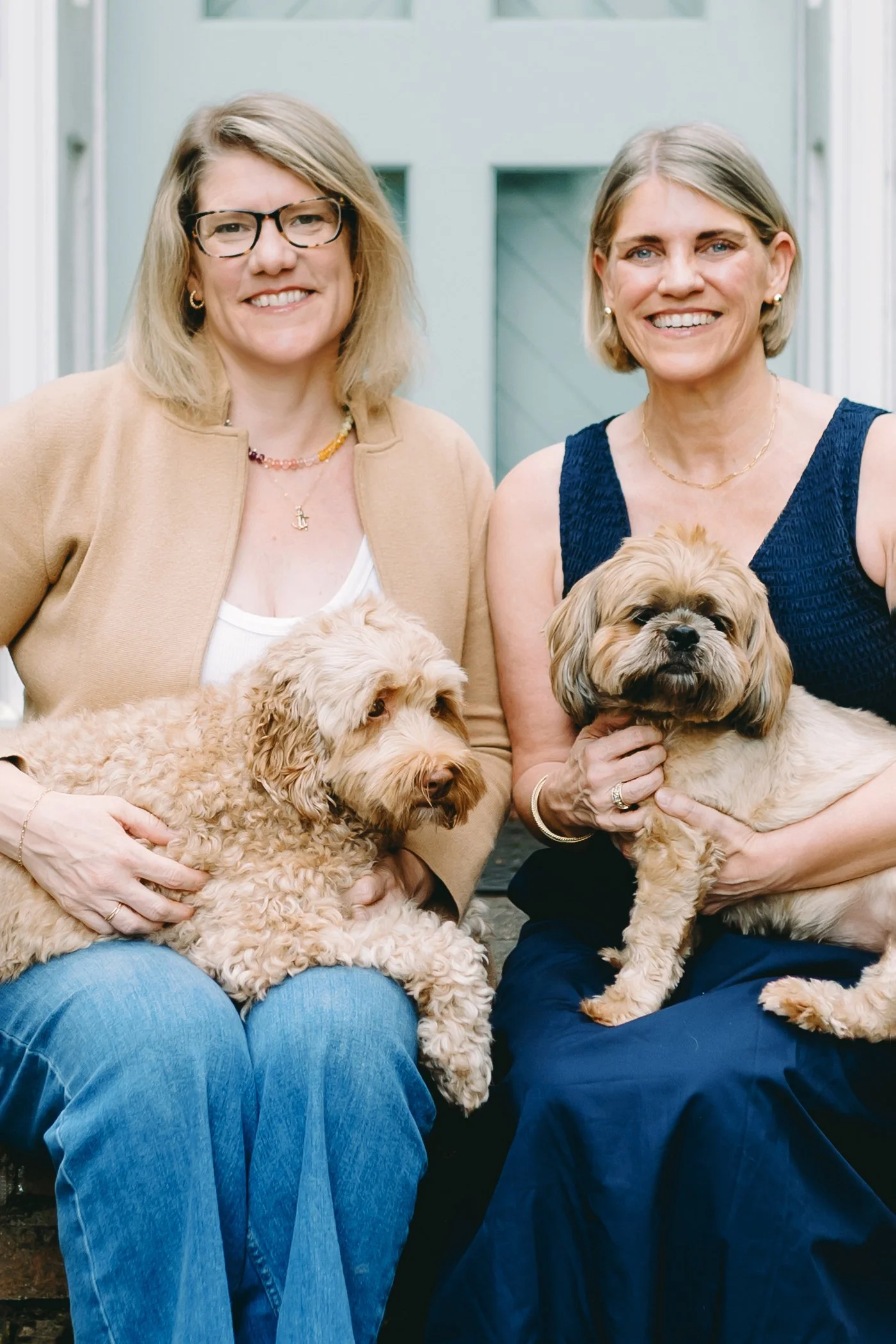 Georgie and Lottie owners - Alonsa Riddle and Natasha Sewell holding their dogs