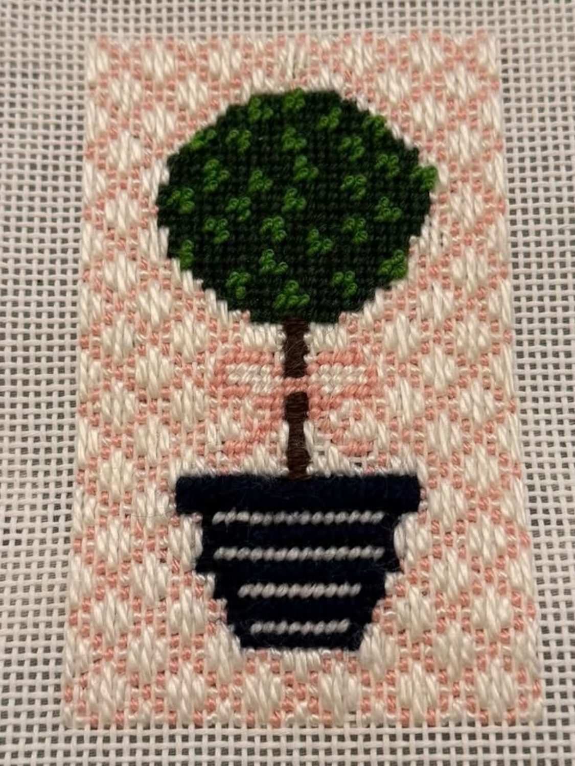 french knots and a decorative background stitch on needlepoint
