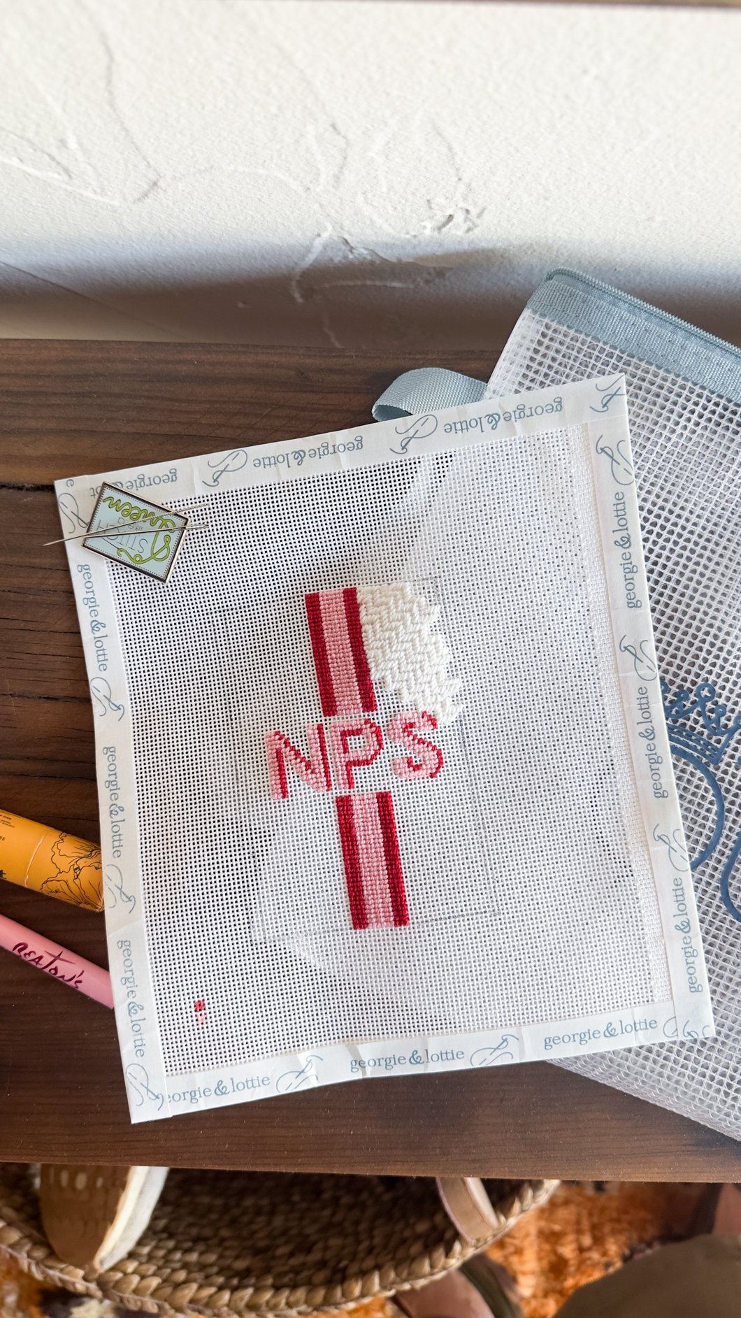needlepoint design in an analog bag