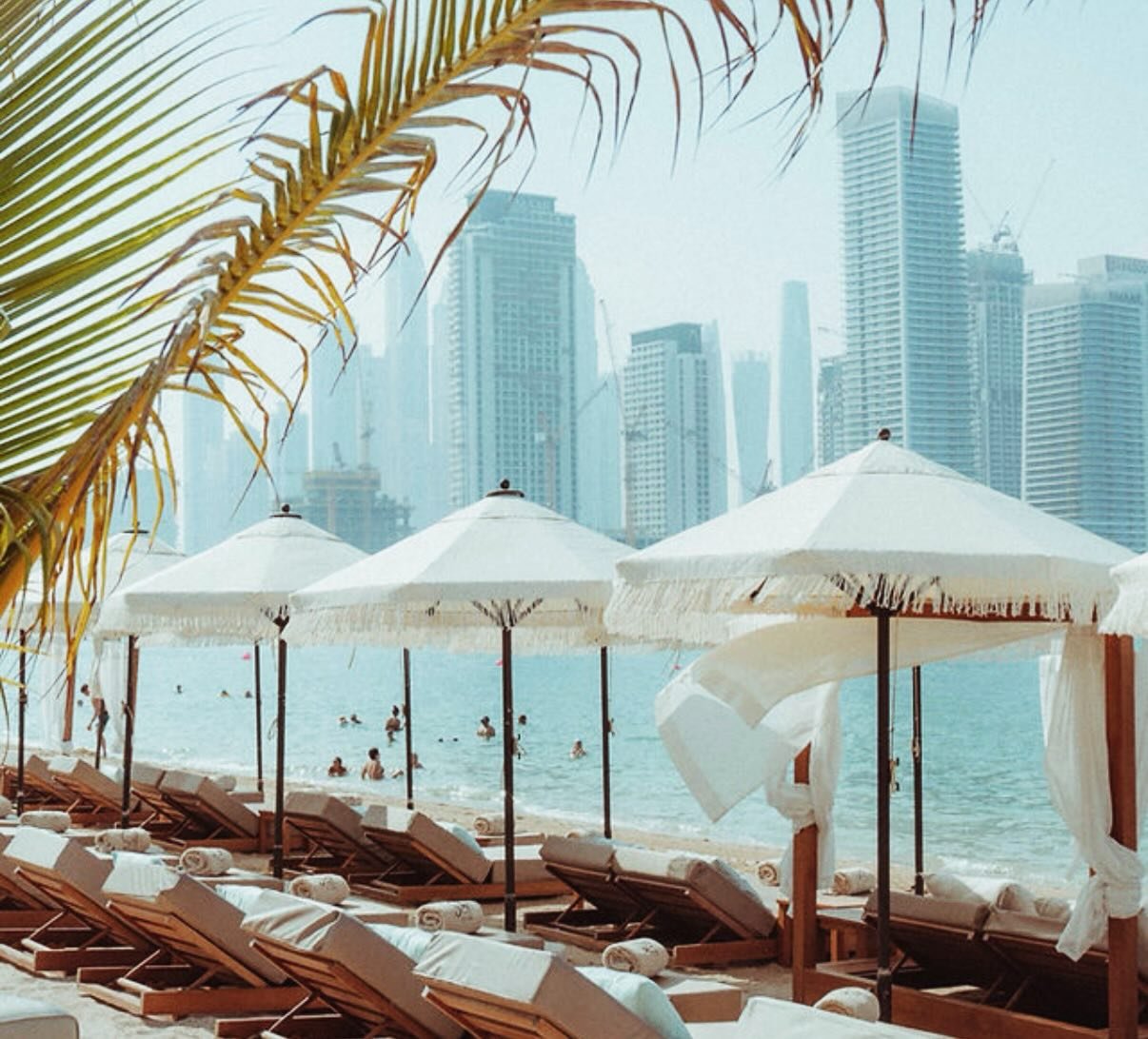 A beach day, with a city in the background.

#chasingthesun☀️ #wildhertrabel #sunescape #gosomewherewarm
