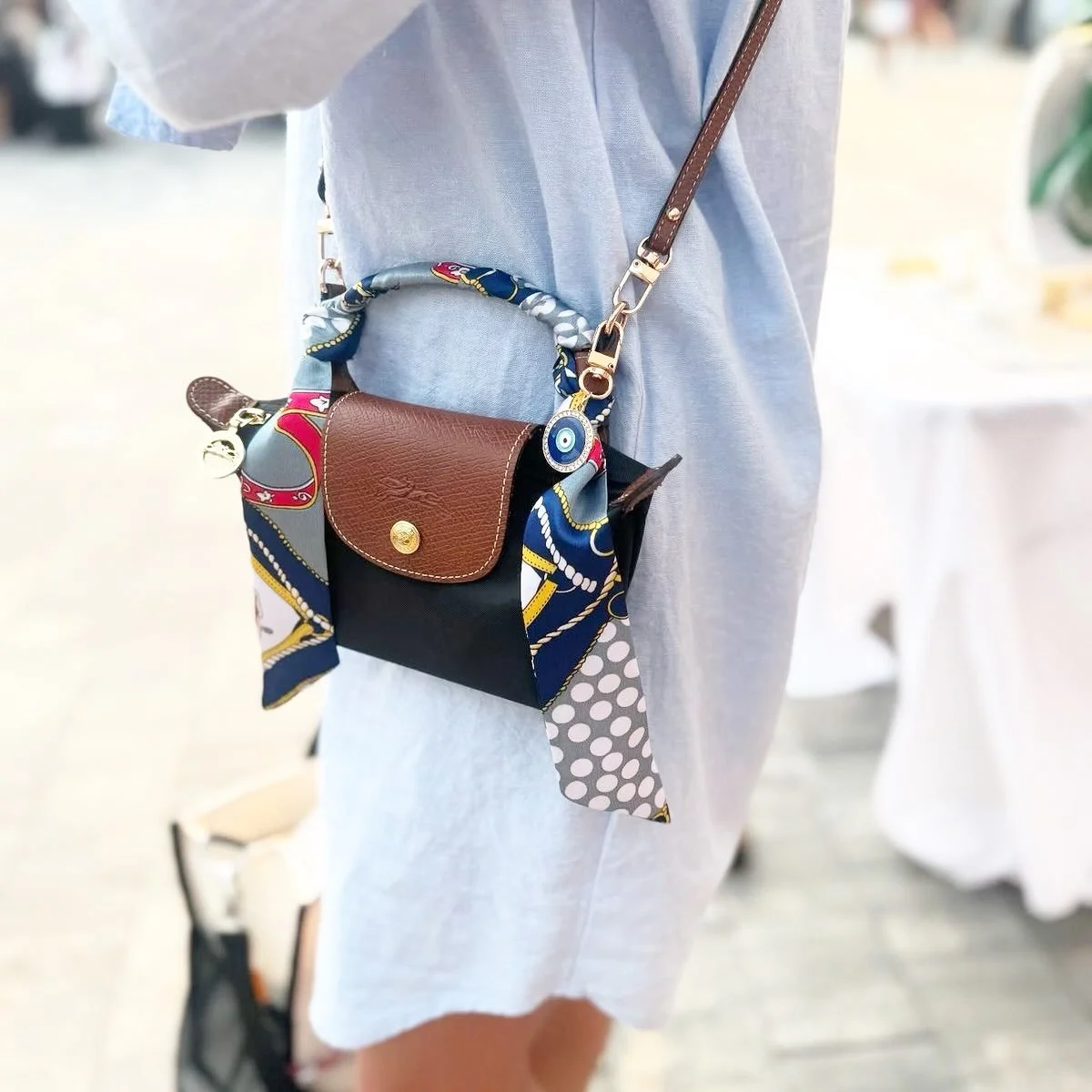 Never underestimate the power of a scarf.

One of my favorite styling tricks is using a scarf in an unexpected way. Tie one around the handle of a favorite handbag, wear it at your neck, add it to your hair, or even loop it through a belt.

It&rsquo;