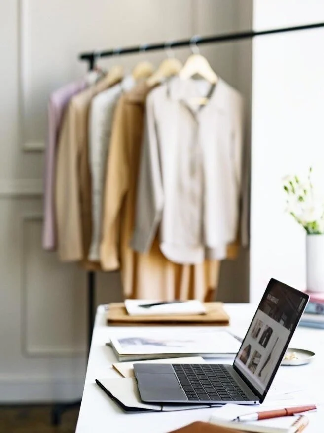 Clothes hanging in corner of virtual stylist's office