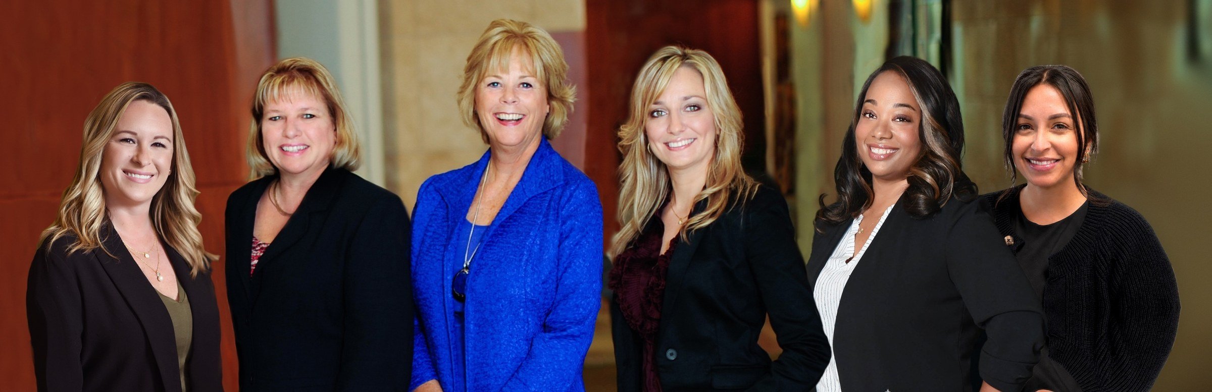 The six women of the Asset Planning, Inc. team standing together in their office
