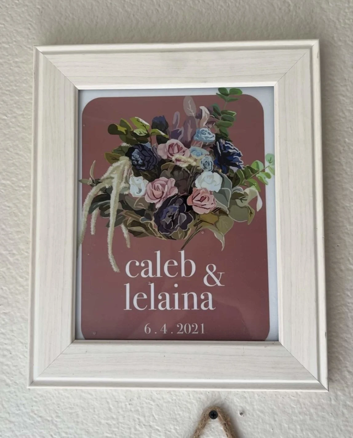 Framed wedding bouquet portrait with floral design, displaying the names Caleb and Lelaine and the date June 4, 2021.