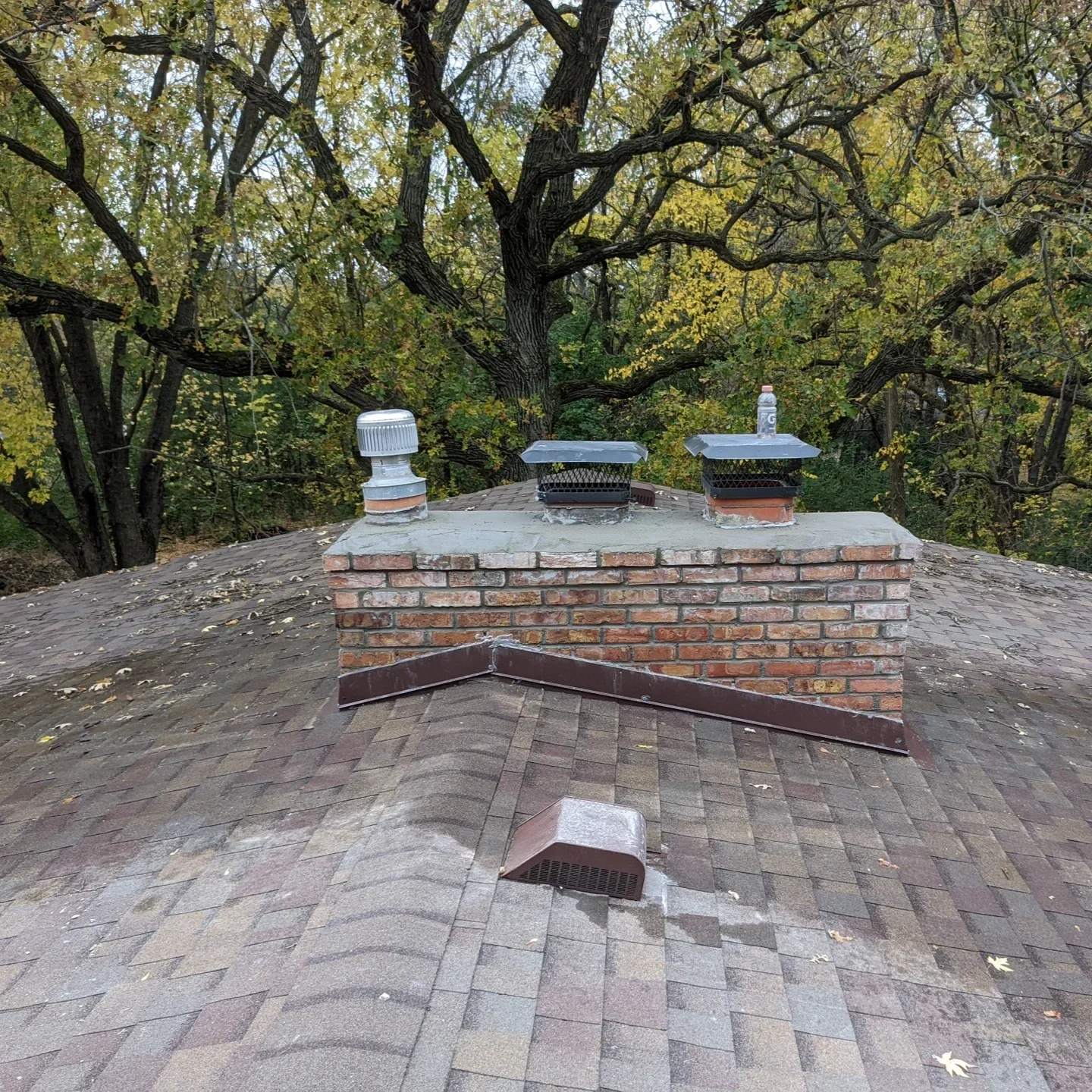 Home inspector examining an aging St. Paul chimney for cracks, water damage, and structural issues to ensure safety.