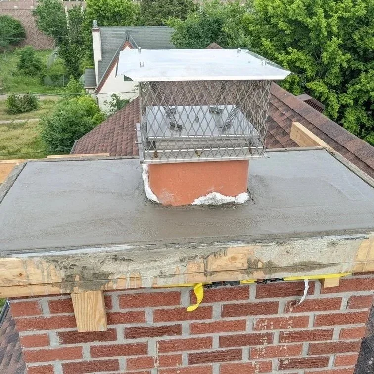 St. Paul chimney showing flashing, crown, and masonry exposed to snow and ice, highlighting areas prone to leaks.