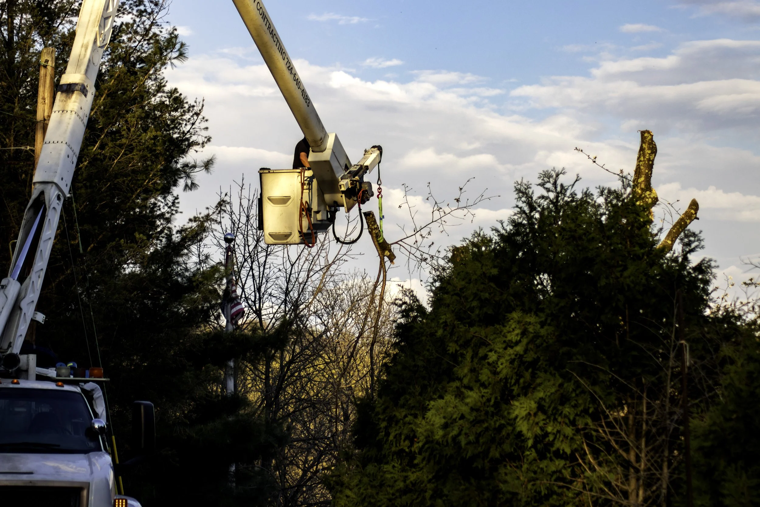 RPW Contracting removing large tree limb with high-reach boom truck in Jeannette, PA — safe and affordable tree services