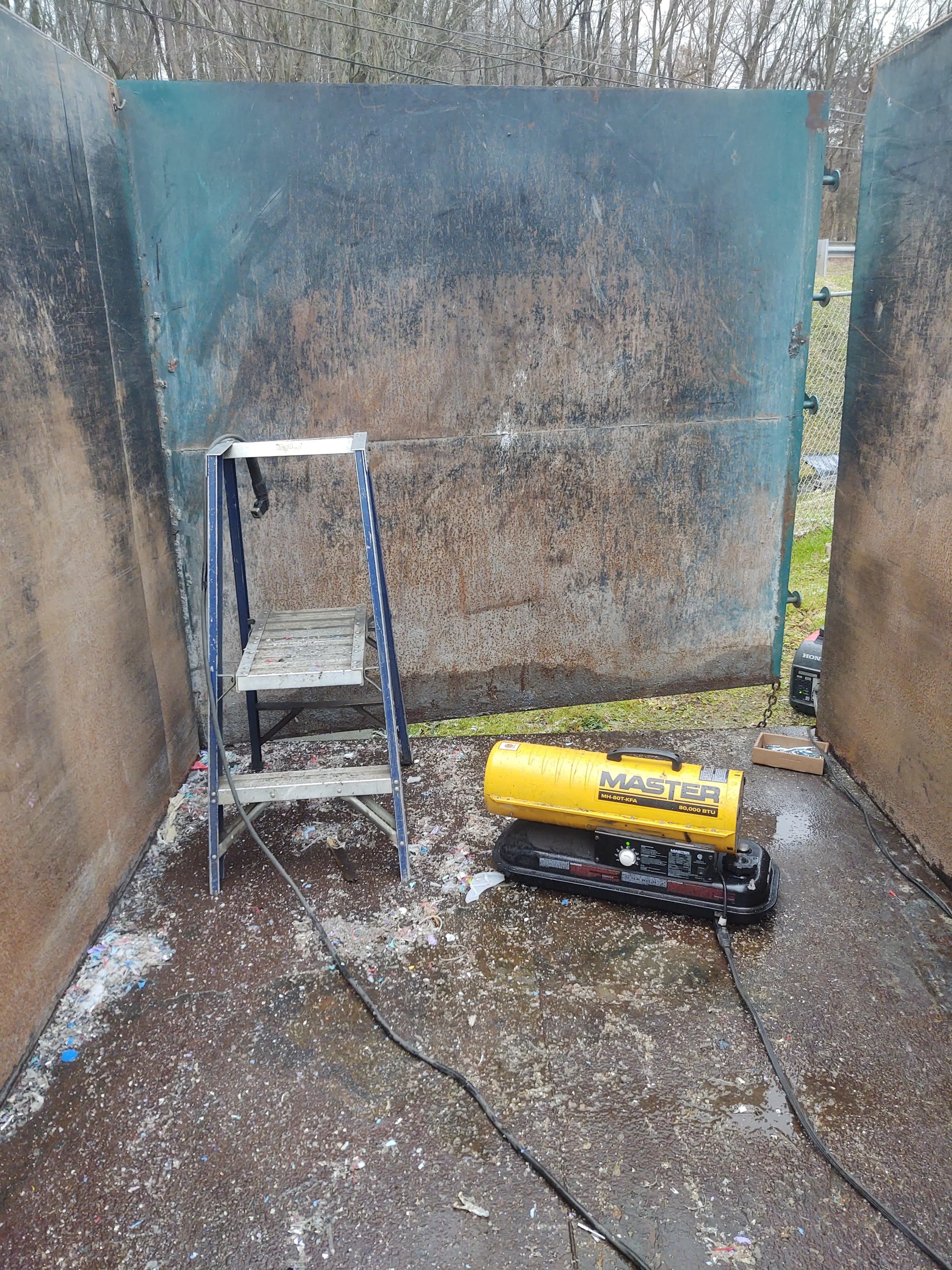 On-site steel panel welding and repair of roll-off dumpster box by R.P.W. Contracting in Jeannette PA, part of mobile truck and trailer repair service