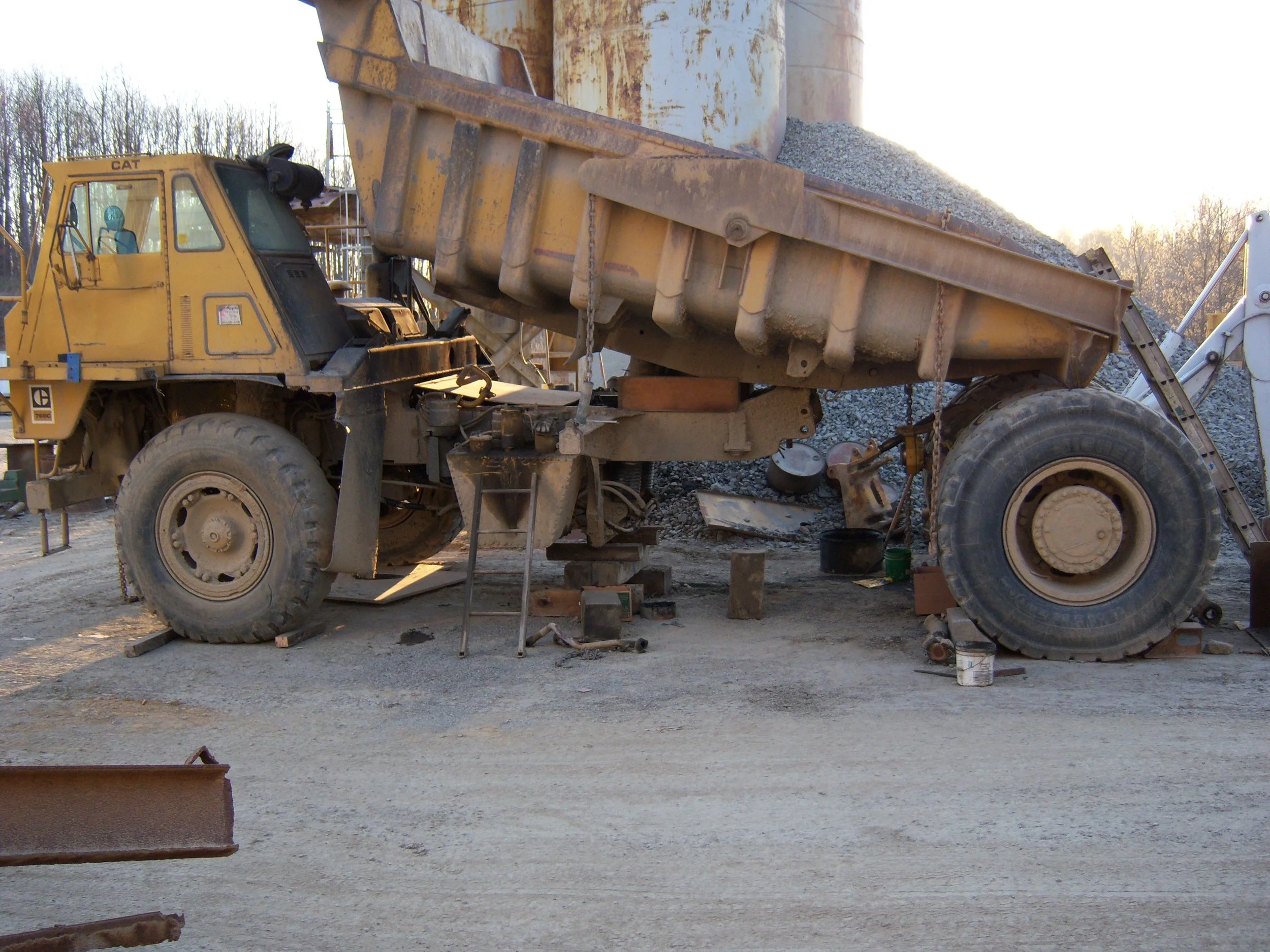 CAT off-road dump truck undergoing heavy trunnion repair by RPW Contracting in Jeannette, PA.