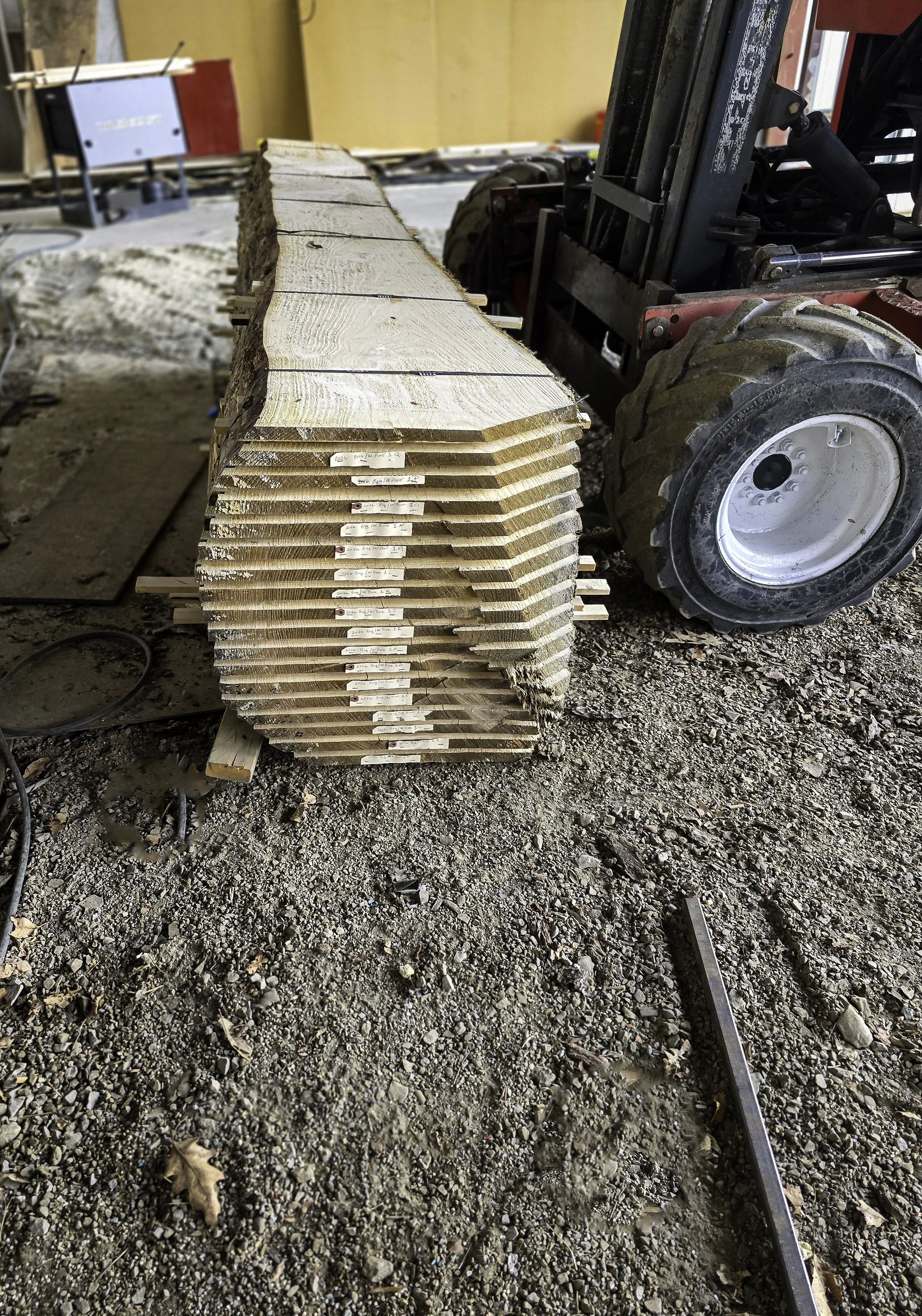 Stack of live-edge lumber slabs stickered for air drying at R.P.W. Contracting’s sawmill service in Jeannette, Pennsylvania.