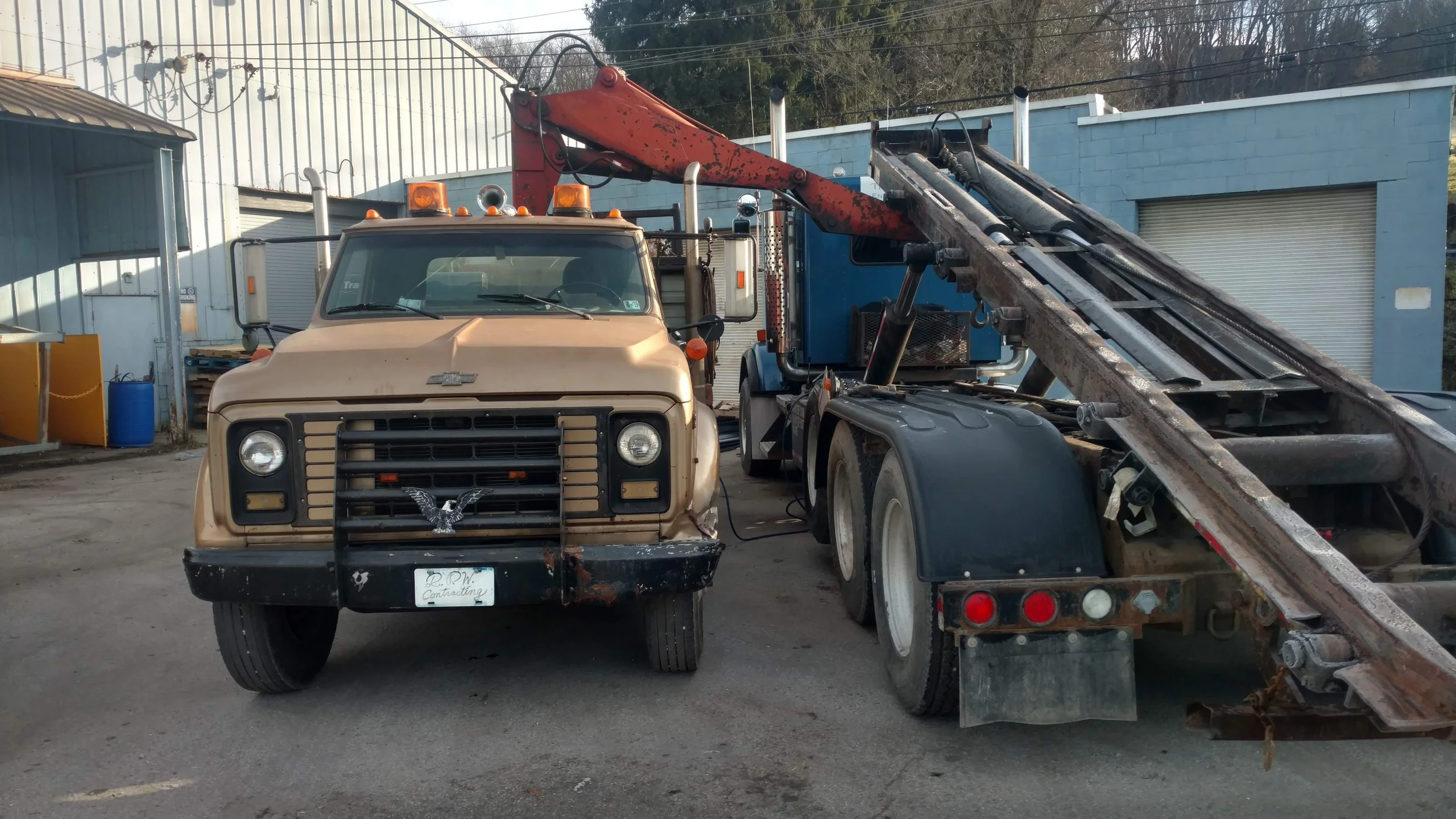 R.P.W. Contracting heavy-duty service truck and trailer setup for equipment hauling in Jeannette, PA