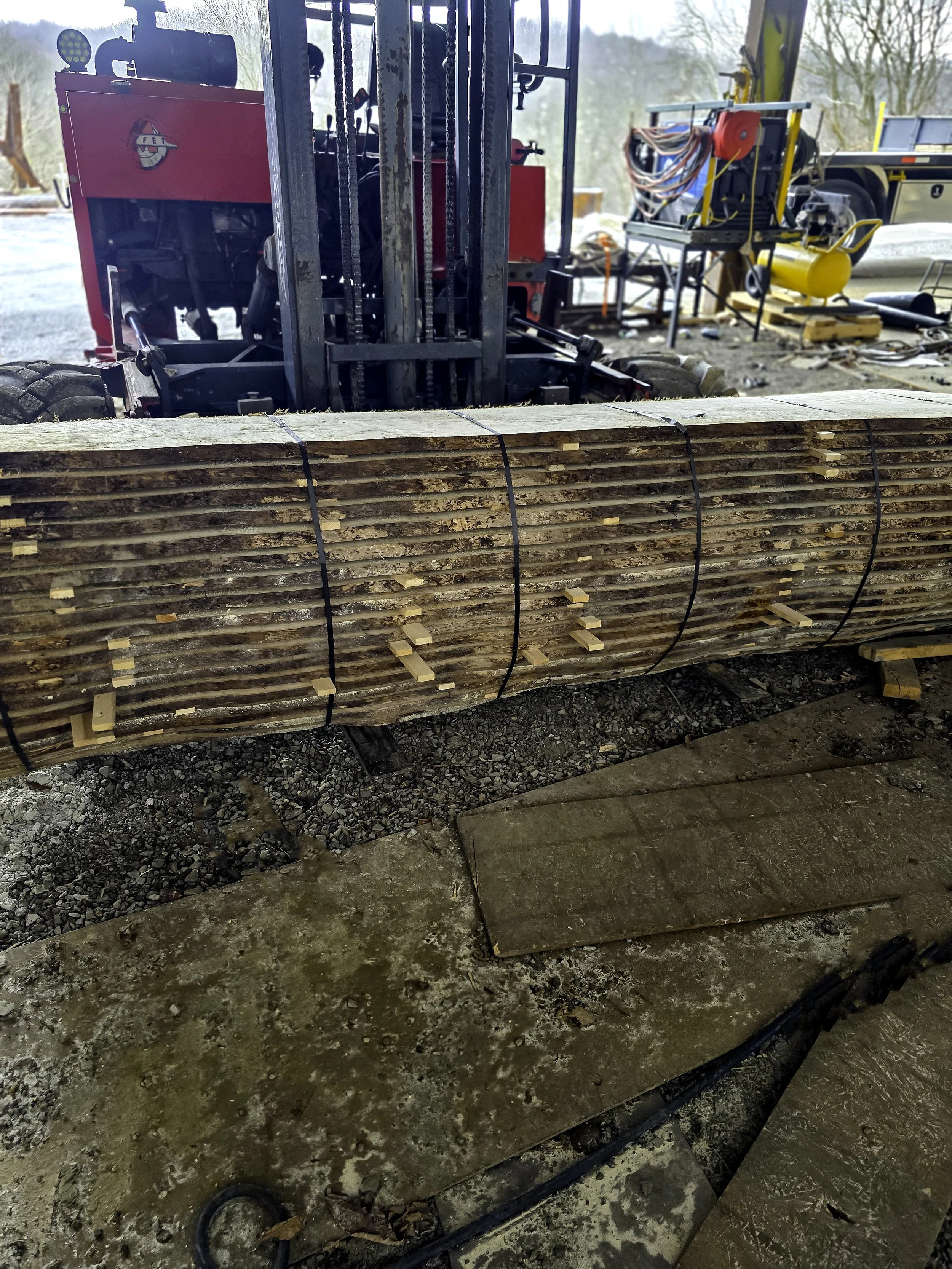 Banded stack of rough-cut lumber with spacers for air drying at R.P.W. Contracting sawmill service in Jeannette, Pennsylvania.