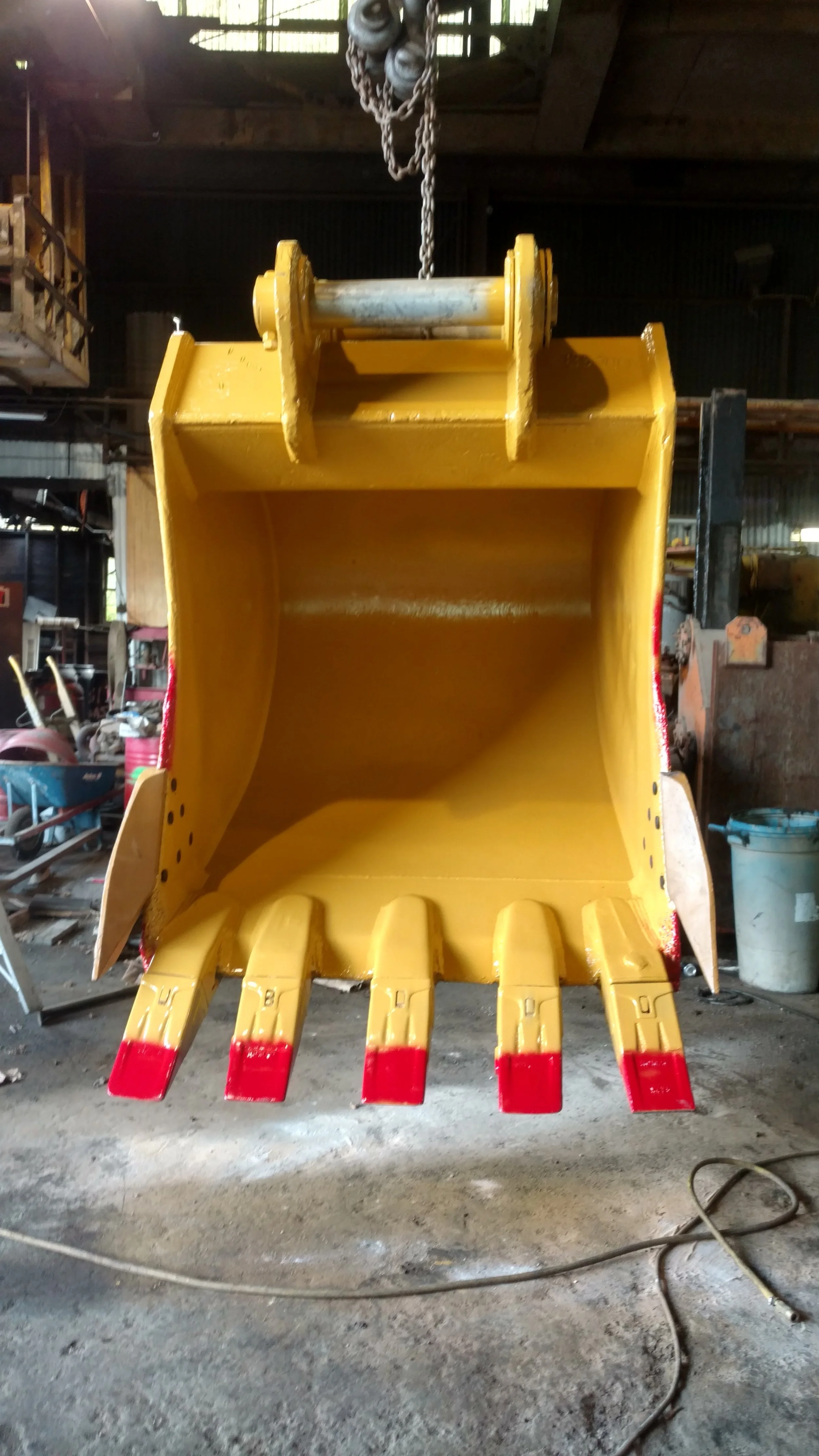 Refurbished and freshly painted excavator bucket by RPW Contracting in Jeannette, PA — complete heavy equipment welding, restoration, and finishing service