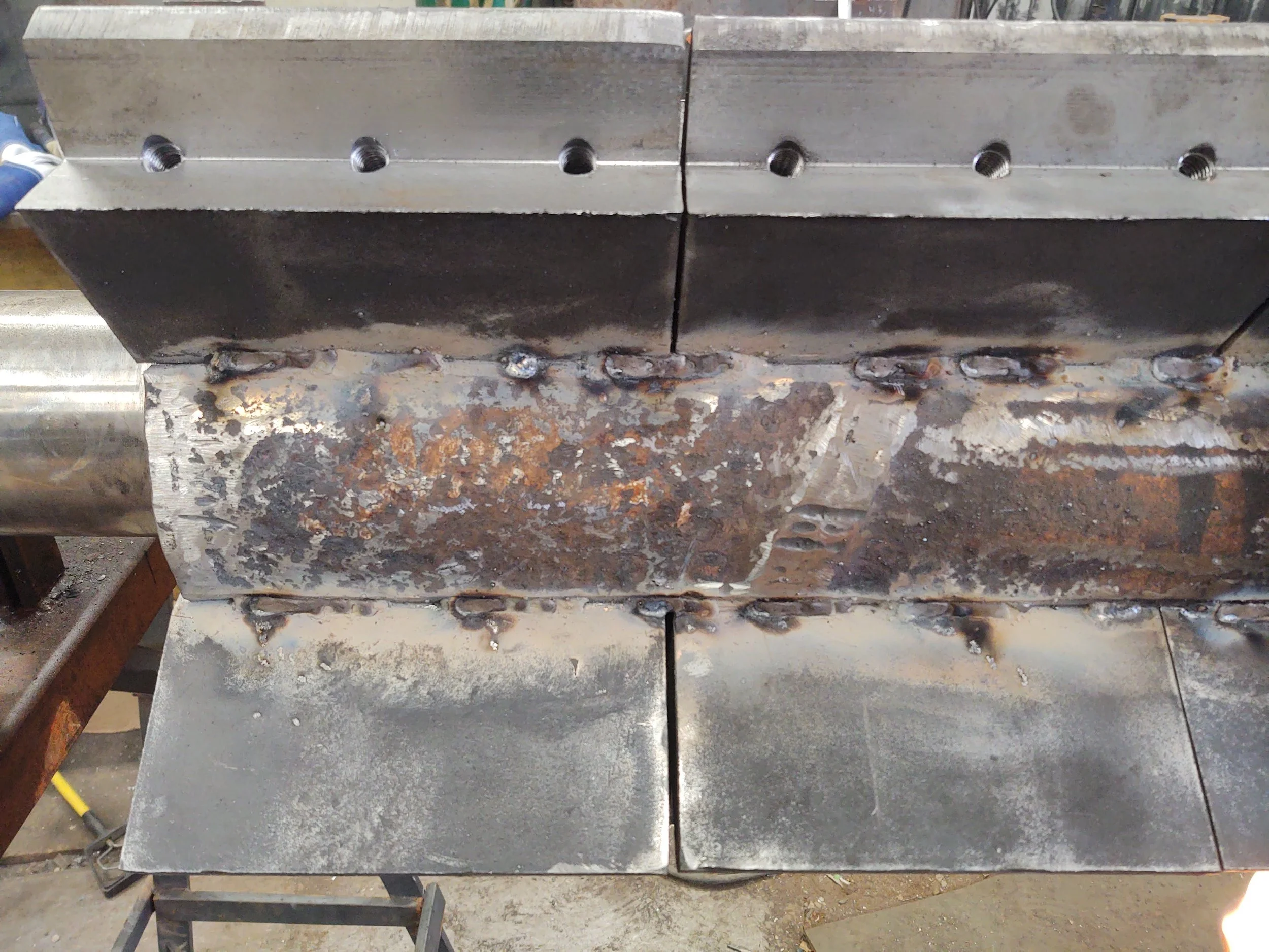 Close-up of custom heavy shaft fabrication with precision welding and steel plate cladding by RPW Contracting in Jeannette, PA