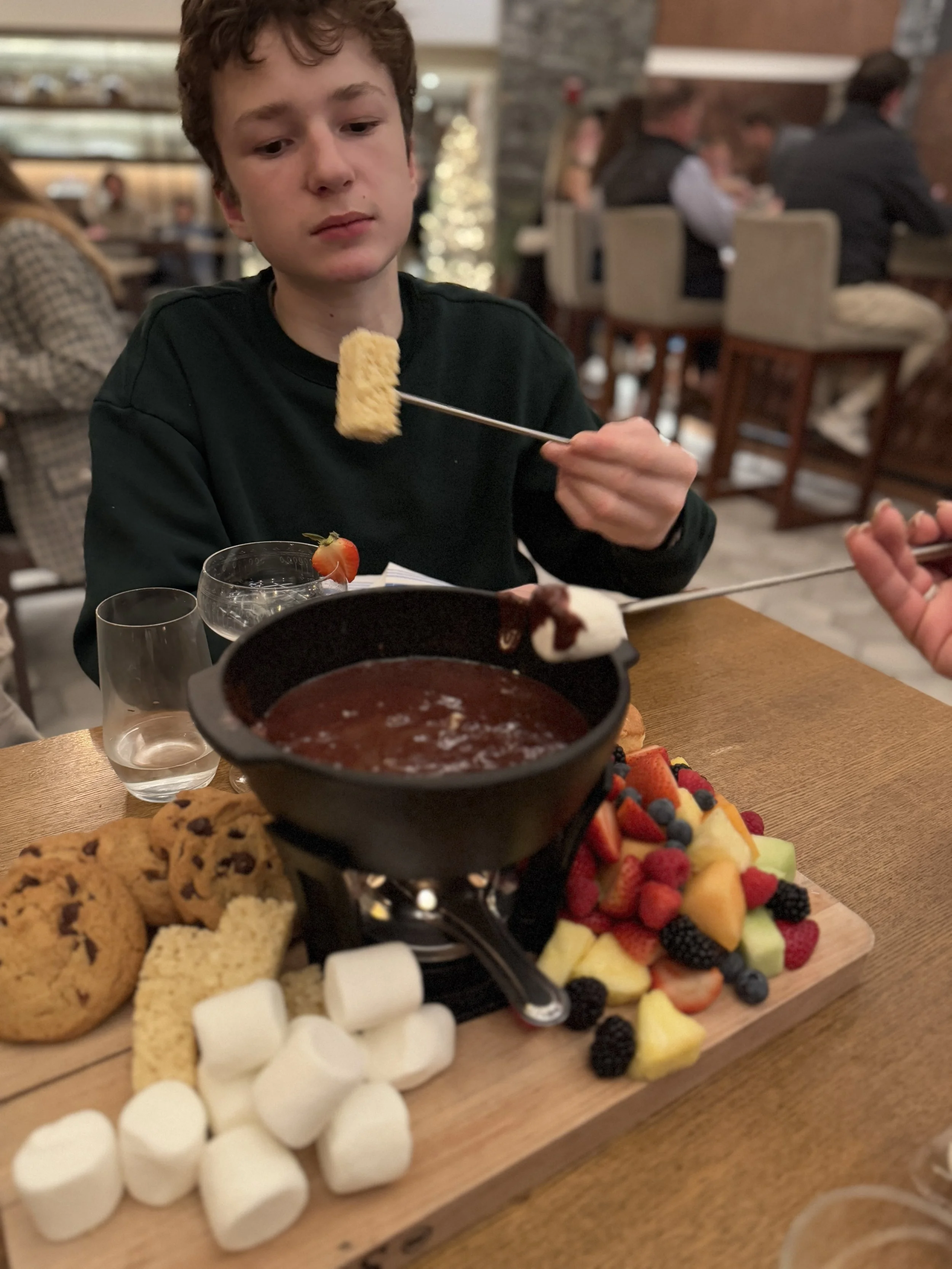 A photo of my son enjoying chocolate fondue in the Lodge at Spruce Peak in Stowe, Vermont.