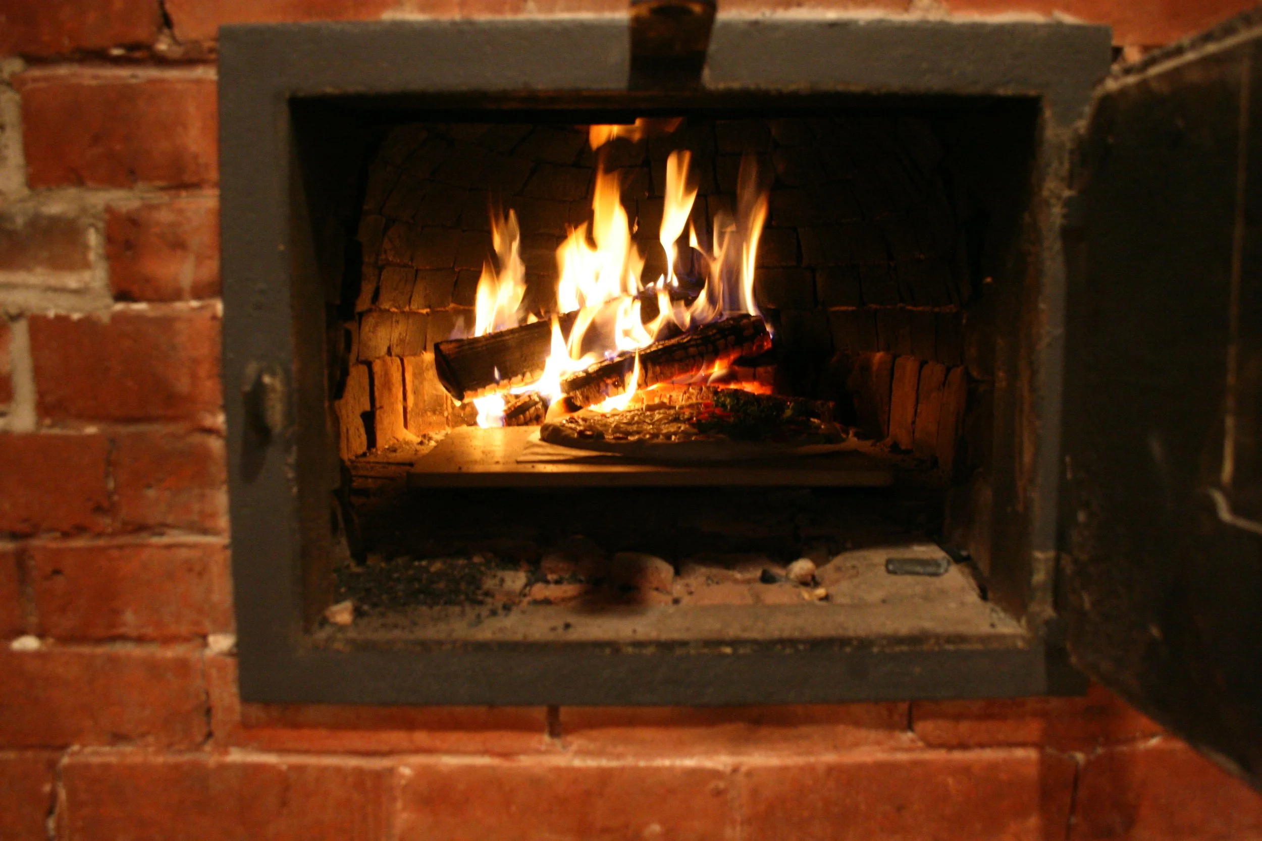 A photo of the brick oven in our 1700 farmhouse being used.