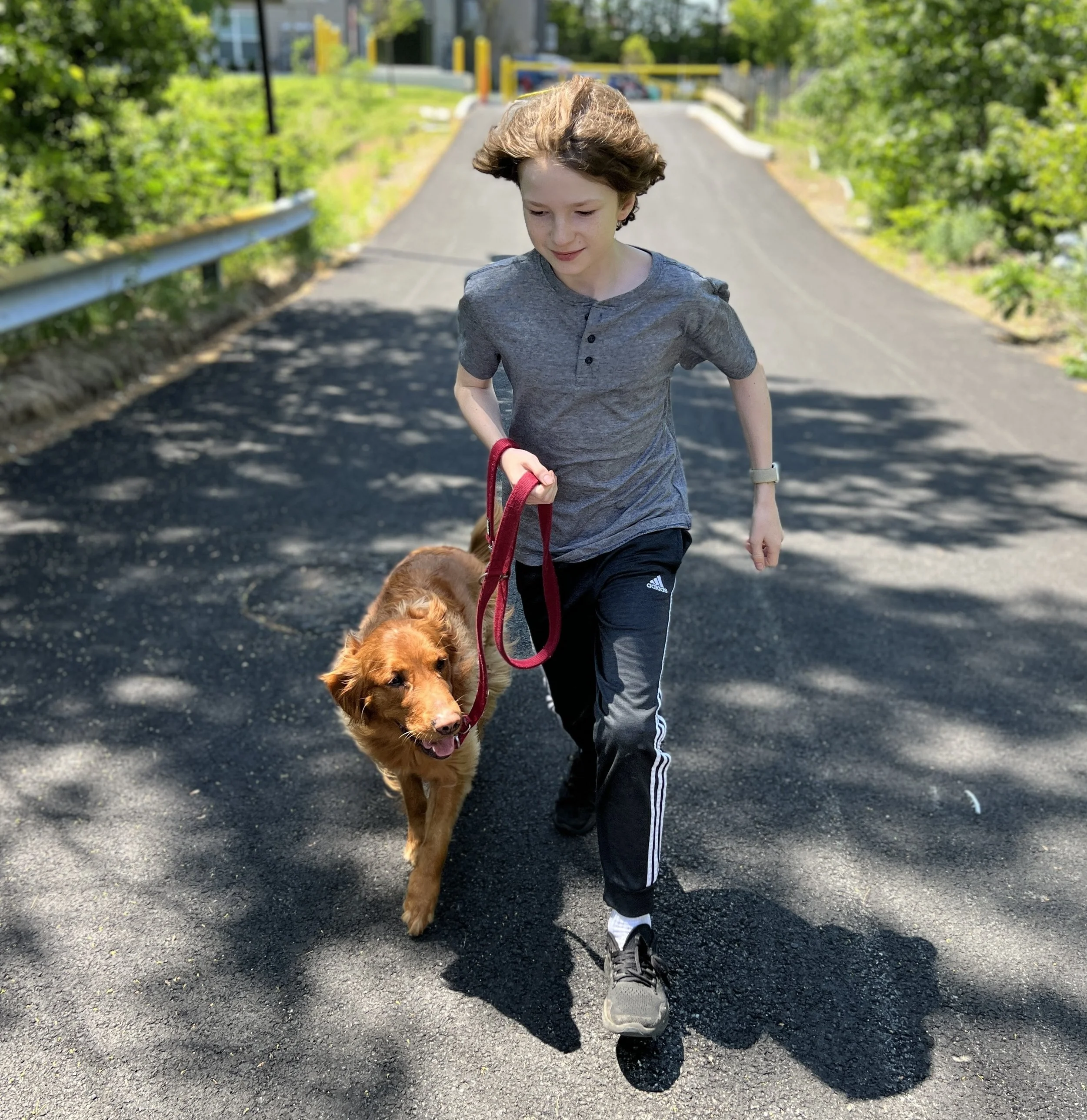 A photo of my son years ago, jogging with our Golden Retriever Dug.