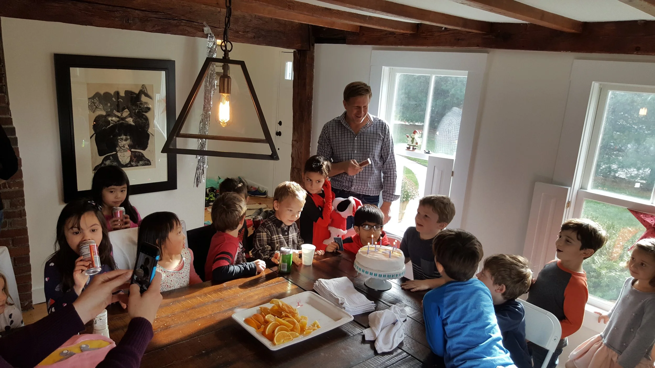 A photo of my son at his 6th birthday blowing out the candles with his friends.
