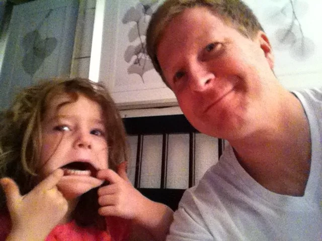 A photo of my daughter and I many years ago, making funny faces.