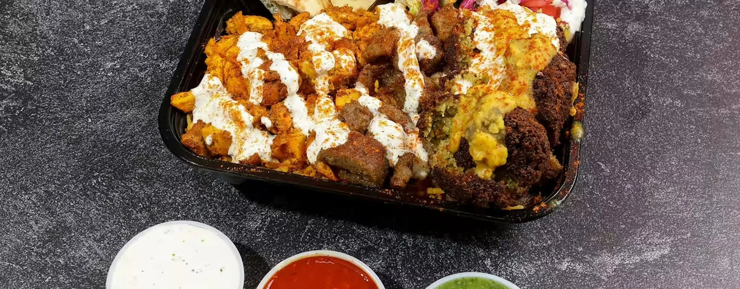 Our juicy chicken and lamb along with falafel served with rice , salad, and toasted pita bread slices and your choice of sauces